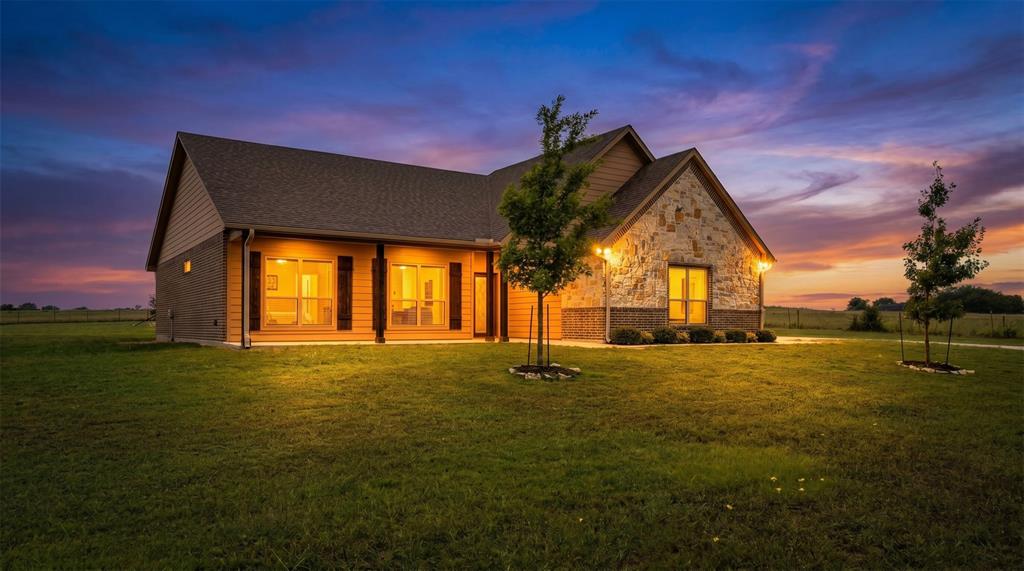 Welcome home to 571 County Road 2830 — where country charm meets modern living on a beautiful 1-acre lot in Decatur! This stunning 2022-built, 3-bedroom, 2-bath home offers 1,731 sq ft of thoughtfully designed space with no HOA. The open-concept layout is highlighted by a breathtaking floor-to-ceiling stone fireplace, laminate flooring throughout the main living areas, and plush carpet in the bedrooms. The chef-inspired kitchen features granite countertops, a large island, eat-in dining, and a walk-in pantry — perfect for entertaining. Retreat to the spacious primary suite with a garden soaking tub, separate walk-in shower, and generous closet space. Enjoy outdoor living from the charming front porch or the covered back porch. Bring your toys — the property includes an attached 2-car garage, 2 carports, AND a metal RV carport with covered overhang. City water and sewer. Zoned to Slidell ISD. This one truly checks every box — schedule your showing today!