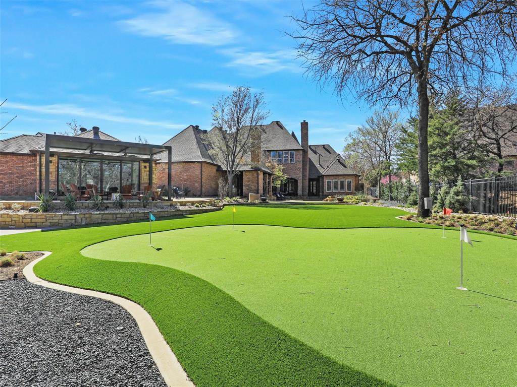 Welcome home to this updated, transitional home in Exclusive Westwyck Hills with the BACKYARD OASIS of your dreams. Nestled among trees on a beautiful street, this gorgeous home greets the most discerning Buyers with designer finishes throughout. Enter the impressive entry Foyer to find the stunning Dining room with Butlers Pantry and Walk-in Wine Room. Step into the Great Room, ready for family and friends, with an open floor plan with the Kitchen and Breakfast room with quaint fireplace. The Kitchen is Chef ready with top-of-the-line SubZero fridge, built-in ice machine, Wolf appliances, 2 large islands with quartzite counters, large Pantry + Mom's planning desk area. The Downstairs Media is adjacent to the Great Room. Two Executive offices provide for comfortable work-from-home space. Settle into the Master Retreat with sitting room, remodeled spa bath with larger shower, soaking tub and 2 vanities, plus spacious closet. Private Guest Suite is also down, along with a full Pool Bath. Upstairs you find 3 private Bedrooms with walk-in closets and updated bathrooms, 2nd Laundry room, plus a Game Room. Head to the large Club-Game Room with TV area, full Bar-Mini Kitchen with island, room for game tables, and then into the separate 11 seat Media-Screening room.  Step outside to the most incredible yard, completely re-envisioned and remade, with multiple covered Sitting Areas, 2 fireplaces, full outdoor Kitchen, updated pool, water features, fire bowls, completely new landscaping, new irrigation system, full landscape lighting, outdoor sound system, Putting green and Sport Court! Step into the separate and just completed 26x21 WELLNESS Center with space for Full Gym, floor-to-ceiling pivot doors to the outside covered patio + custom Finnish Sauna (space could also be converted back to a 2 car garage).