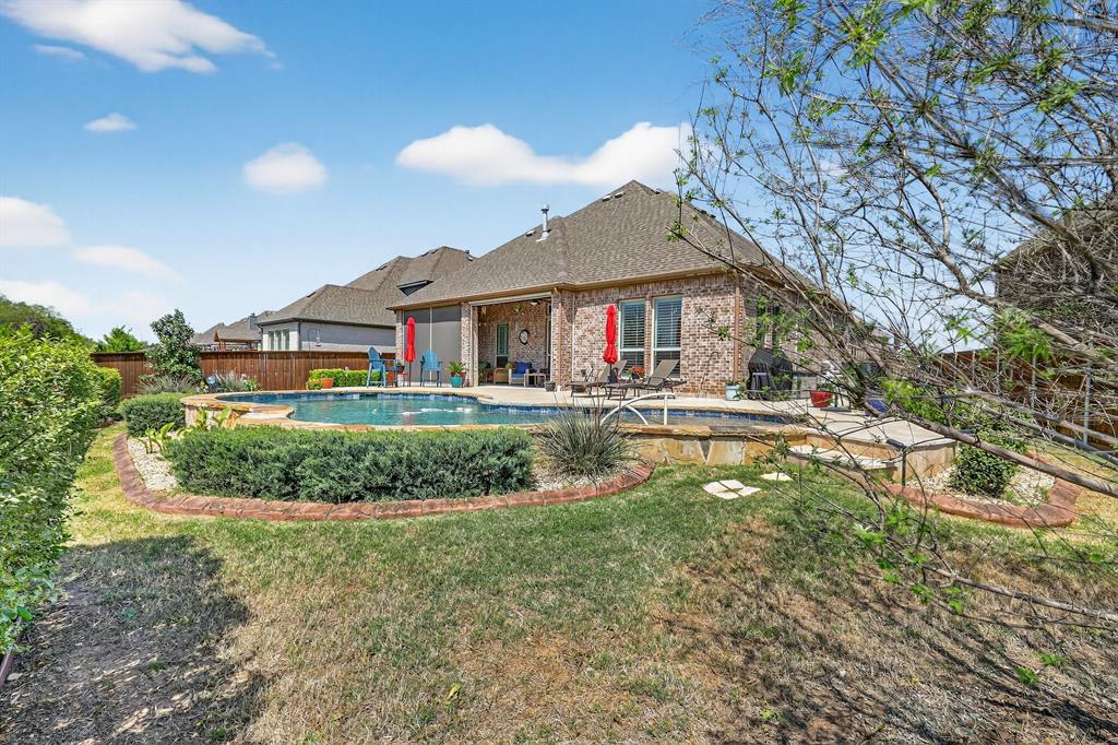 You'll fall in love with this beautiful blend of luxury and comfort, showcasing stunning features throughout this impeccably maintained home with wood floors, new Class 3 roof that helps with energy efficiency while providing lasting durability, and plantation shutters that enhances the home's elegance throughout. Situated on a premium lot backing to a greenbelt, offering privacy and natural views! At the heart of the home, the gourmet kitchen impresses with a grand center island, gas cooktop, double ovens, and striking granite countertops, perfectly designed for both entertaining and everyday living. The kitchen flows effortlessly into the spacious living area, where a beautiful stone fireplace creates a warm and inviting atmosphere. The primary suite offers a relaxing retreat with an ensuite bathroom with dual sinks, granite countertops, walk in whirlpool bathtub equipped with aromatherapy system that promotes deep relaxation and stress relief, and a separate frameless shower,  and a large walk in closet. Designed with everyday functionality in mind, the home features a mudroom and an oversized laundry room complete with built in cabinetry, a utility sink, and direct access to the garage. The laundry space also connects seamlessly to the primary suite's walk in closet and mud area. Step outside to your personnel backyard oasis, perfect for summer days and relaxing evenings. Enjoy the covered back porch that features motorized power shades that provide added UV protection and comfort, a fireplace with gas logs and a beautiful sparkling pool. Situated in La Frontera Estates that offers access to walking trails and a community splash pad, all just minutes from Eagle Mountain Lake, major highways, dining, shopping and entertainment!