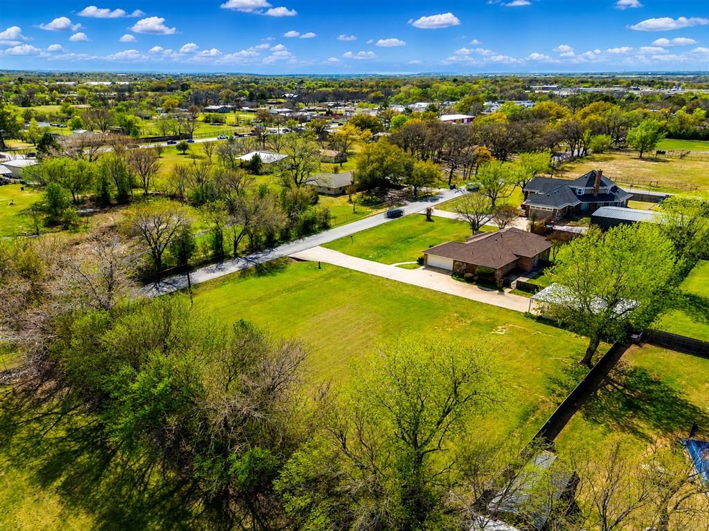 NEW ROOF!  A rare find in Burleson! This versatile property sits on a spacious one-acre lot and offers incredible potential. The home features oversized bedrooms, including a front room that can serve as an office or second living area. The inviting living room boasts abundant natural light and a fireplace. The kitchen features cabinets galore and new counter tops that were just installed. A separate utility room adds convenience. The property includes both an attached garage and a detached 31x23 detached garage, which presents endless possibilities—it could be transformed into a future mother-in-law suite, workshop, or additional storage. With a total of six covered parking spaces, including a carport, your vehicles will be well protected, especially during unpredictable spring weather. The expansive backyard is shaded by mature trees, perfect for relaxation or entertaining. Plus, the extra lot offers the opportunity to build another home or explore commercial potential. Conveniently located off Rendon Road, near shopping and I-35, this property is a must-see! NO HOA!