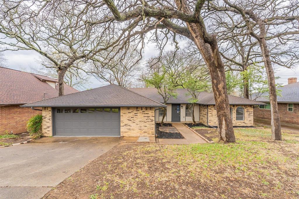 Welcome home to 2105 Castle Oaks Drive in Arlington. This beautifully renovated 3-bedroom, 2-bath, 2-car garage home is not only the definition of move-in ready but offers a fresh Contemporary feeling. Every detail has been thoughtfully updated, blending modern style with a cozy, timeless feel. The bright, open kitchen is a standout, featuring white shaker cabinets, new appliances, a stunning backsplash, and natural light that makes the space feel fresh and inviting. Neutral designer colors throughout, fresh interior paint, and brand-new flooring create a clean, effortless look that works with any style. The living area offers a cozy fireplace and flexible layout, perfect for relaxing nights in or entertaining guests. Spacious bedrooms include walk-in closets, giving you comfort and storage without compromise. Step outside to a fully fenced backyard with a dedicated sitting area, ideal for morning coffee, weekend gatherings, or unwinding at the end of the day. The long driveway, mature trees, and established neighborhood add charm, privacy, and curb appeal you just can’t replicate. Perfectly located in Arlington, this home delivers the best of both worlds: a peaceful, established community with easy access to shopping, dining, and major routes. Truly turnkey. All that’s missing is you.  Conveniently located just 6 minutes from the University of Texas at Arlington, with easy access to a variety of shopping centers, restaurants, and entertainment, and only 7 minutes from Highway 30, making commuting a breeze. Don’t miss your chance to own this fantastic home in a prime area.