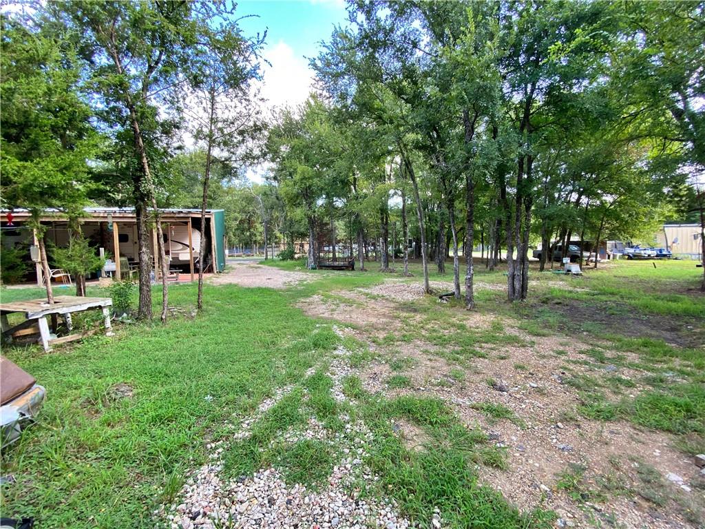 Charming Land with Utilities and Mobile Home Friendly! Nestled in a tranquil and peaceful area, this beautiful 0.34-acre lot offers the perfect opportunity for your new home. The property is well-equipped with all essential utilities, including a septic system, water meter, and electric meter, ensuring a hassle-free setup. The lush trees provide a natural canopy, adding to the serene ambiance of the location. Making this an ideal spot for those looking for flexibility and convenience.
Additionally, the property boasts easy access to Highway 35, offering quick connections to nearby amenities and cities. Don't miss this opportunity to own a quiet paradise in Elm Mott.