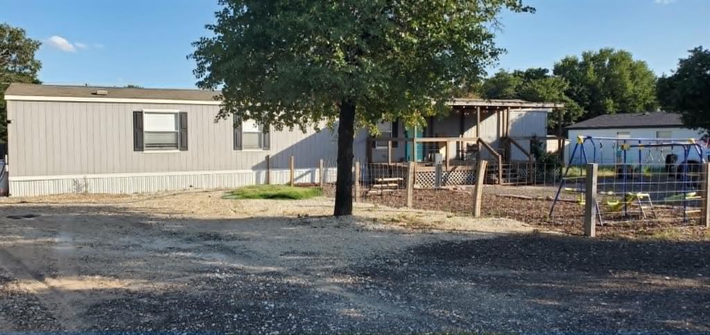 Welcome home to this well-maintained 3-bedroom, 2-bath single-wide mobile home situated on a generous ½-acre lot. Enjoy relaxing mornings on the large, welcoming front porch and appreciate the comfort of an open-concept layout designed for both everyday living and entertaining.
The thoughtfully designed split floor plan offers privacy for the spacious primary suite, featuring a large en-suite bath & walk-in closet. The heart of the home is the bright kitchen, complete with a center island, oversized commercial-style farmhouse sink, industrial-style faucet, and a 3-door stainless steel refrigerator. A dedicated dining room and additional eat-in kitchen space provide plenty of room for family meals and gatherings.
Additional features include a separate laundry area, convenient doggie door, and a generous gravel parking area. In the back yard, you'll find a fully sodded, level, fenced backyard—perfect for pets, play, gardening, or outdoor entertaining.
Recent improvements include a retrofit completed in 2024, providing added peace of mind. Conveniently located with easy access to US Highway 83, this property offers the perfect blend of country space and accessibility.
Don't miss this move-in-ready property offering comfort, functionality, and plenty of outdoor space!