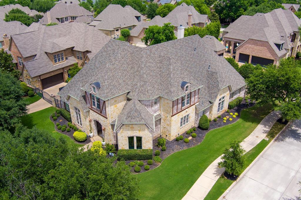 Welcome to your Dream Home in Estes Park, Southlake Texas, Carroll ISD! This home sits on a corner lot and boast exceptional features including new white oak hardwood flooring, stunning staircase, designer lighting and so much more. The main living area is perfect for entertaining with an abundance of natural light illuminating the living room and newly renovated gourmet kitchen, with quartzite countertops with custom cabinetry. The Primary Suite is a private retreat featuring a spa like bathroom and walk in closet, private access to pool and wall of windows with view of pool. The first floor includes a media room, executive office with built ins and fireplace, formal dining, half bath, additional bedroom with ensuite, wet bar, walk in pantry, mudroom and updated laundry room. There are 2 additional bedrooms upstairs each with en suite and a large game room with wet bar. The back yard is its own oasis with a pool and spa surrounded by mature landscaping, and outdoor living with built in grill and fireplace. Enjoy morning coffee and peaceful evenings. Perfect for entertaining. Additional features located in documents. Don't wait, make this stunning home yours today!