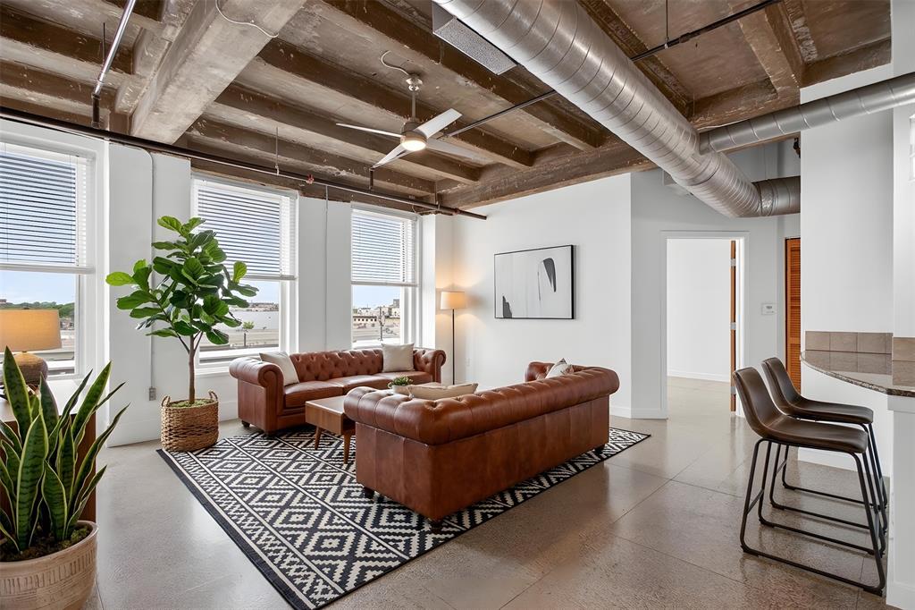 NEW PRICE!!! Urban sophistication meets historic charm at the iconic Texas & Pacific Lofts, where true downtown Fort Worth living comes to life.
This rare 2 bedroom, 2 bathroom residence on the 3rd floor offers a front row seat to the rhythm of the city, with expansive windows framing Fort Worth views and filling the space with natural light. Original terrazzo floors, high concrete ceilings, and exposed ductwork create an authentic industrial feel. The kitchen flows seamlessly into the living and dining areas, ideal for both entertaining and relaxed daily living. Refrigerator, washer, and dryer convey. Beyond the residence, T&P Lofts offers a true sense of community. Residents enjoy gatherings like mahjong nights, beer club, movie nights, and coffee in the owners lounge. Pet friendly community allowing up to two pets.
Amenities include 24 hour concierge and on site management, high speed internet, a state of the art fitness center, owner's lounge, indoor pool, club room, and a media room. Landscaped courtyards with grills, an expansive resident patio and lounge, and secure, low maintenance living within a landmark Art Deco building. Parking spaces are included, with additional storage and reserved parking available for lease.
Located in the heart of downtown Fort Worth, this condo offers unbeatable proximity to Texas A&M School of Law, the Medical District, local shops, coffee spots, and the vibrant dining and nightlife of Sundance Square, Near Southside, and Magnolia Avenue.
Direct access to both TEXRail and the Trinity Railway Express. Travel to DFW Airport, Grapevine, the Dallas Medical District, American Airlines Center, and downtown Dallas just steps from your door. Live in a piece of Fort Worth history without sacrificing modern convenience. An ideal option for downtown professionals, medical and airport employees, or those looking to simplify and downsize while staying connected to the city’s energy.