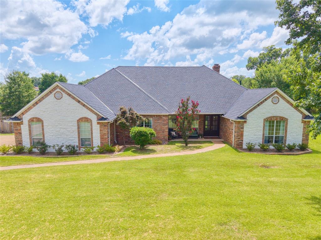 *New Pricing Creates Incredible Buying Opportunity* In the heart of Flint, Texas, this updated and spacious home offers comfort, privacy, and convenience just 20 minutes from downtown Tyler. Featuring 4 bedrooms, 2.5 bathrooms, a 3-car garage, and nearly an acre, there's plenty of room to live, relax, and entertain. Inside, you'll find an inviting layout with tasteful updates throughout, including abundant natural light from large windows. The brick-and-stone exterior is complemented by a brand-new Grand Manor designer roof system, and the new back porch shade system provides outdoor comfort at the push of a button. Upgrades include: engineered wood floors, 3cm quartzite countertops, a central vacuum system, and an oversized primary suite with a soaking tub. Enjoy peace of mind in this gated neighborhood with quick access to Tyler and Lake Palestine. Move-in ready, well-maintained, and full of East Texas charm.