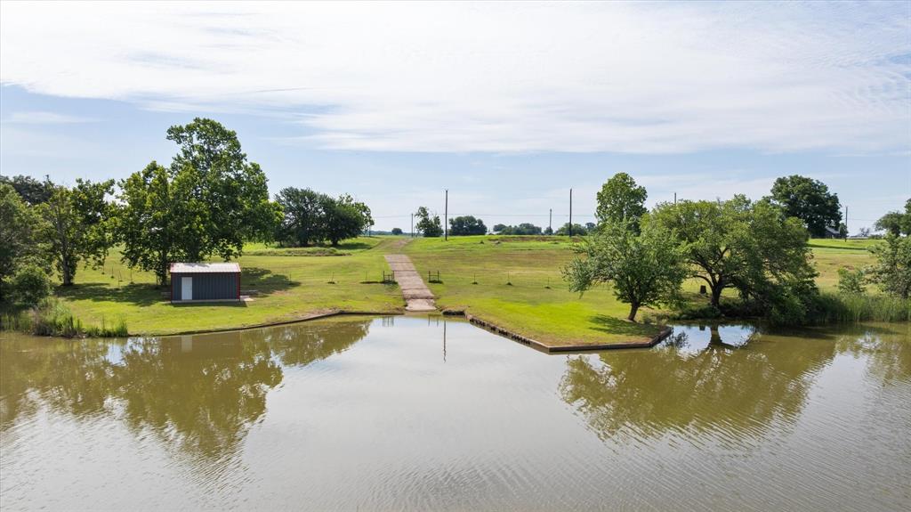 This is a Very Unique property, 53.739 acres of Lake front land just North of Historic Granbury.  There are not many opportunities left to find land that is on Lake Granbury that can be purchased for lakefront homes, developed for homes, subdivided for whatever your heart desires.   This property has approx 1600 feet of shoreline.  Part of this farm has approx 34 acres of leased grass farm which is a year to year lease and can be extended as an income generator, or used for other needs.  The property has a 60 x 80 metal shop with over 2000 square foot of barndo living space inside, shop and barndo have central heat and air.  There is a shed attached to the shop for storage or working from.  This property back in late 70s was a small multi site RV park and has pads sites still located on property. Approx 32 RV sites were on the property and makes it a great potential to be a RV park.   Property has 2 water wells, a loafing shed for a horse or other animals,  abundance of wildlife roam the property from deer, ducks, geese, and of course fishing from the bank or the small dock on the property.  A private boat ramp allows the owner to launch their own boat from the land.  Native pecan trees and hard woods cover the lake area and land around the shop.   Owner is willing to look at all offers, and is willing to subdivide the property in larger parcels.  Grass lease area could be sold or cut out, as well as the land along the lake or even the Bardo and surrounding acreage.   Secluded, private and lakefront makes a great combination and awesome piece of property for your dreams to come true.