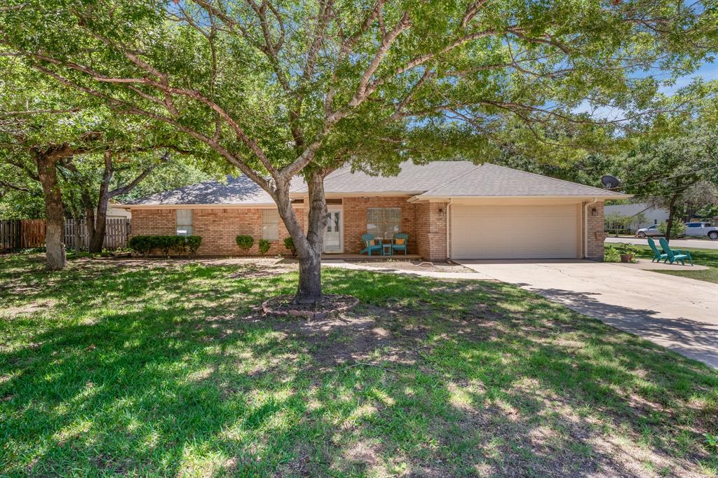Check out this clean 3-bedroom, 2-bath home nestled on a corner cul-de-sac lot in the desirable DeCordova Bend Estates. Step inside to an inviting, spacious living and dining area featuring wood-look tile plank flooring throughout the common spaces, offering both style and durability. The large kitchen offers ample white cabinetry, an electric range, microwave, dishwasher, and plenty of prep space for everyday cooking and entertaining. Retreat to the spacious primary suite, complete with two generous walk-in closets and an ensuite bath featuring dual sinks with a granite vanity and a stunning walk-in shower. The two additional well-sized bedrooms share a large secondary bathroom with dual sinks and a shower-tub combination. Outside, enjoy the tranquility of a fully fenced backyard with a large covered porch — perfect for unwinding or entertaining guests — plus great gardening areas and a 10x20 concrete-floored storage building with electric. Located just 45 minutes from downtown Fort Worth in a guard-gated community, residents also enjoy an impressive lineup of amenities: golf, pickleball, tennis, a community pool, clubhouse dining, lake access, and more. Don't miss your chance to own this exceptional home — schedule your tour today!