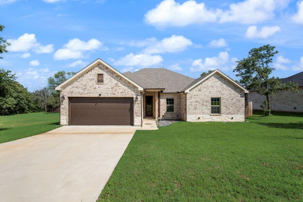 Amazing 4 Bedroom, 2 Bath home at an exceptional price point featuring a BRAND NEW ROOF! This beautifully maintained one story offers an open-concept floor plan with a spacious living room anchored by a cozy wood-burning fireplace and custom wood-stained mantel.
The stunning kitchen is sure to impress with white cabinetry, gorgeous quartz countertops, a farmhouse sink, stainless steel appliances, subway tile backsplash, abundant counter space, and a generous pantry for exceptional storage.
Privately tucked away, the spacious primary suite features elegant tray ceilings and a great ensuite bath with dual vanities,quartzlike vanity, a soaking tub, separate shower, and large walk-in closet. The split-bedroom layout provides added privacy, while the secondary bedrooms each include ceiling fans. The secondary bath offers dual sinks and quartz-style countertops.
Designer touches throughout include 6-inch custom high profile baseboards, wood look tile flooring in select areas, abundant recessed lighting, and tasteful finishes that create a warm, modern feel.
Step outside to enjoy the extended covered patio overlooking a private, fenced backyard with a lush lawn.
The curb appeal is outstanding with a brick-and-stone elevation, a beautiful wood stained front door with decorative wrought iron that covers the door's glass insert, coach lights, and landscape uplighting. Additional features include a sprinkler system, gutters, a wood privacy fence with steel posts, and a brand-new roof for added peace of mind.
Lovingly cared for and gently lived in, this move-in-ready home is ready for its next owners to make lasting memories.