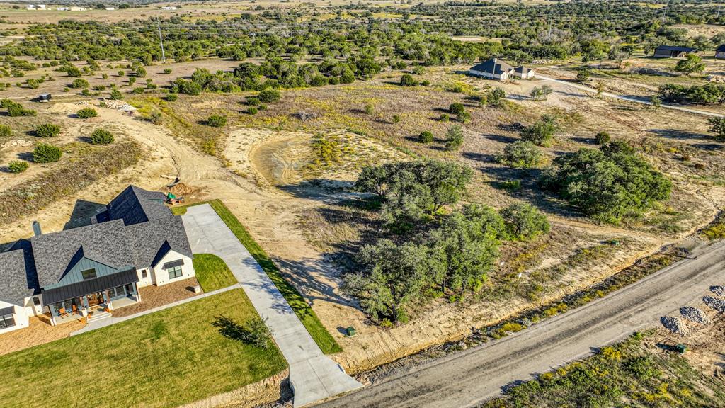 Two acre lot in the gated community of Eagles Bluff, located in Brock ISD! The lot has been mostly cleared, with few trees kept for privacy. The neighborhood has a stocked fishing pond and spring fed creeks. Community including underground utilities, paved roads and available high-speed internet. Well and septic are required. Bring your own builder today!