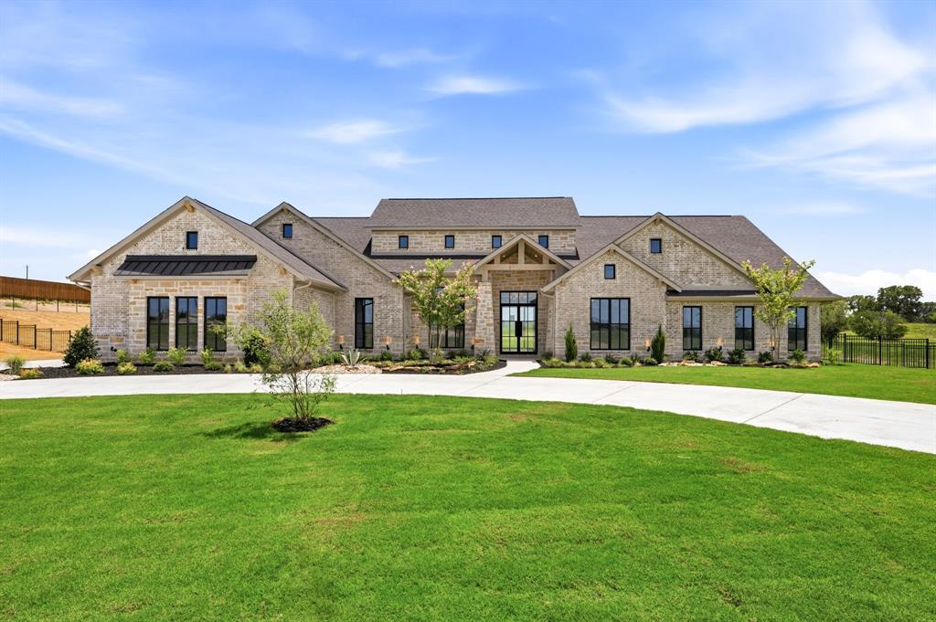 Luxury Redefined – Texas Hill Country Elegance on 2 Acres in Fleming Pointe.
Experience luxury living at its finest in this stunning Texas Hill Country-inspired estate, perfectly situated on a private two-acre homesite within the exclusive gated community of Fleming Pointe. Thoughtfully designed with exceptional craftsmanship and timeless architecture, this remarkable single-story home offers an unparalleled blend of elegance, comfort, and functionality.
Featuring 5 bedrooms, 4 full baths, 1 half bath, and a 4-car garage, the home welcomes you through a dramatic glass entry into a grand foyer that flows into an impressive, vaulted family room. Expansive sliding doors open to vaulted covered patio, creating a true indoor-outdoor living experience. Complete with an outdoor fireplace, this inviting space is ideal for year-round entertaining.
The heart of the home is the chef's kitchen and spacious dining area that overlook the family room. Just beyond the kitchen, a generous game room with a wet bar, a private media room, and a secluded guest suite with its own ensuite bath—perfect for overnight guests or multigenerational living.

The owner's retreat occupies its own private wing, offering a peaceful sanctuary complete with a spa-inspired bath featuring dual vanities, a freestanding soaking tub, an oversized walk-in shower with dual shower heads, and an expansive custom walk-in closet. An adjoining bonus room provides incredible flexibility as a second study, fitness room, craft room, nursery, or private sitting room.
Three additional bedrooms are thoughtfully positioned in their own separate wing, each offering ensuite bath and walk-in closets.
Designed for both grand entertaining and everyday living, this exceptional single-story floor plan gives everyone their own private space while bringing loved ones together in beautifully designed gathering areas.
Available now for quick move-in—discover refined luxury living in Fleming Pointe.
