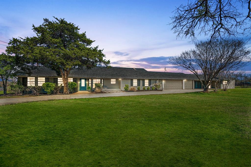 Experience the best of country-style living on 1.67 acres located outside the city limits of Anna, offering space, versatility, and beautiful views while still being conveniently close to major roads, shopping, and dining. With its inviting drive-up appeal and peaceful setting, this property truly feels like a private retreat.

Equestrian enthusiasts will appreciate the barn with four stalls and a round pen, while the property also provides plenty of parking and workspace with a three-car garage plus a three-car carport. Just beyond the carport are two additional finished rooms totaling approximately 200 sq ft of air-conditioned space, perfect for a home office, hobby area, workout room, or extra storage.

Relax on the welcoming covered front porch or head to the backyard where outdoor living shines with a deck, patio, and a beautiful gunite in-ground pool, ideal for entertaining or cooling off on warm Texas days.

Inside, the living room impresses with a vaulted ceiling, crown moulding, and picture frame moulding, along with an amazing view of the surrounding property. A woodburning brick fireplace with raised hearth adds warmth and charm. The kitchen offers a smoothtop cooktop and abundant cabinetry for all your storage needs.

A second living area features a wall of windows, perfectly framing the scenic outdoor views and filling the home with natural light. The primary suite includes a large skylight, a stylish barn door leading into the bath, dual sinks, a separate frameless shower, and a spacious walk-in closet.

Features new HVAC with smart thermostat (2022), new roof (2024), pool resurfacing (2024), and new pool pump (2025). With acreage, equestrian amenities, flexible living spaces, and wonderful outdoor features, this Anna property offers the perfect balance of privacy, comfort, and convenience.
