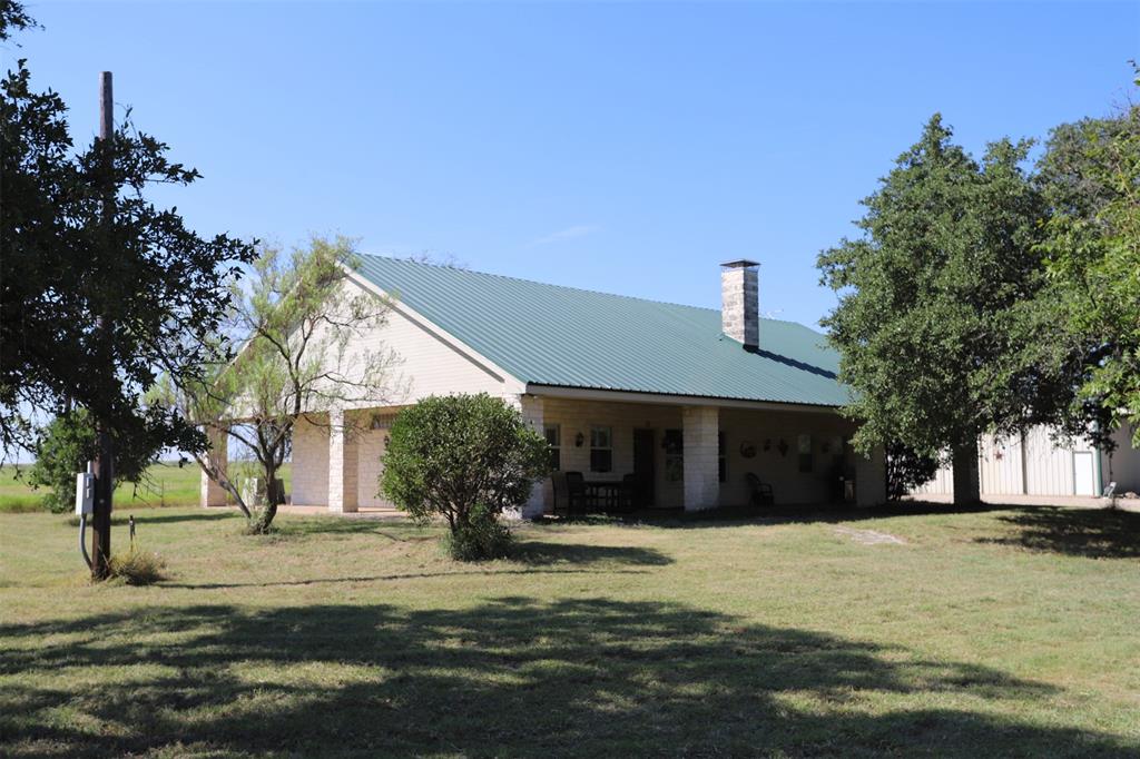 Texas-Sized Charm on 233 Acres in this Stone Ranch Retreat

Discover the ultimate blend of rustic elegance and wide-open freedom with this remarkable stone ranch home set on 233 acres of rolling countryside. With rock veneer siding, a durable metal roof, and a full wrap-around porch, this 4-bedroom, 2-bath retreat is built for both style and serenity.    Inside, stained concrete floors, granite countertops, and a woodburning fireplace create a warm, inviting atmosphere. Thoughtfully designed for year-round comfort, the home includes two HVAC systems, two water heaters, and a built-in tornado shelter safe room for added security and peace of mind.  The land is equally impressive: two stocked ponds, frontage along the scenic banks of Hog Creek, and access to the mouth of an approximately 50-acre lake make this property a haven for outdoor living. Whether you're fishing, kayaking, or simply enjoying the views, water is never far away.  A 2,800 sqft barn with four oversized sliding doors provides endless possibilities—ideal for equipment storage, livestock, or a dream workshop.  Whether you're seeking a private retreat, a working ranch, or an outdoorsman's paradise, this one-of-a-kind property delivers room to roam, water to explore, and a home to love.