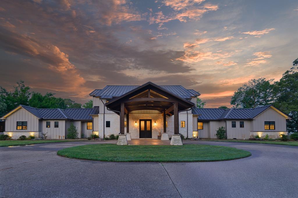 Just 90 minutes from Dallas, this 21-acre waterfront estate on Lake Quitman is conceived as a private resort-style compound designed for scale, seclusion, and a fully immersive lakefront experience.
Comprising six distinct buildings across the property, the estate is designed to comfortably accommodate 32 guests across its residences and guest quarters. Anchored by a substantial main residence and complimented by a separate guest house that sleeps eight and features two full baths, along with additional purpose-built structures including a dedicated smokehouse, a party barn, a fully outfitted game and recreation space, as well as a garage, shed and greenhouse the property functions as a cohesive, self-contained retreat. Whether hosting multi-generational family gatherings, executive retreats, or destination-style weekends, the compound offers the infrastructure and privacy to do so seamlessly.
The setting is defined by expansive water views, over 500 feet of shoreline, and approximately 24 feet of lake depth, supporting boating, swimming, and extended days on the water. A private boat dock accommodates two boats and up to four Sea-Doos, while the lake’s calm, family-friendly character enhances its appeal offering both recreation and refinement in equal measure.
Outdoor living is approached with intention. A tree-lined driveway sets a striking sense of arrival, while multiple screened-in porches allow for year-round hosting and relaxation. The smokehouse serves as a culinary centerpiece—crafted for slow, elevated entertaining—complemented by a large outdoor fire pit for gathering under the stars. A sport court with pickleball capability adds an active dimension.
Open acreage allows for a private helicopter landing area, reinforcing the estate’s accessibility and exclusivity, while the scale of the land ensures privacy rarely found in waterfront properties.
