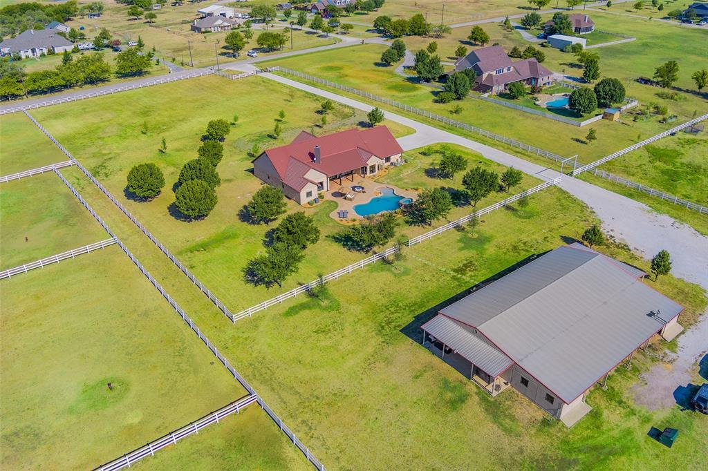 Stunning horse farm located in desirable Aubrey Texas nestled on 10 manicured acres. Suitable for a horse trainer with small operation or the avid equestrian! Contemporary mediterranean one story home boasting superb craftsmanship & attention to detail throughout. Fabulous floor plan enhanced by fine finishes & generous room sizes offering endless entertaining opportunities. Expansive primary suite. Gourmet kitchen opens to breakfast, dining and living room for seamless entertaining. Resort-style backyard with expansive patio overlooking heated pool and spa. Beautiful 14 stalls block barn. Lighted outdoor riding arena, separate paddocks, 1 bedroom studio apartment, 50 amp RV hookup. Property updated in Fall of 2022. New floors, windows, HVAC, fresh paint inside and out. New kitchen and master bathroom. Added gated entrance and concrete drive. Updated pool & landscaping around house and barn. 40 mins to DFW Airport. 50 mins to downtown Dallas. Fiber high speed Internet! AG EXEMPT