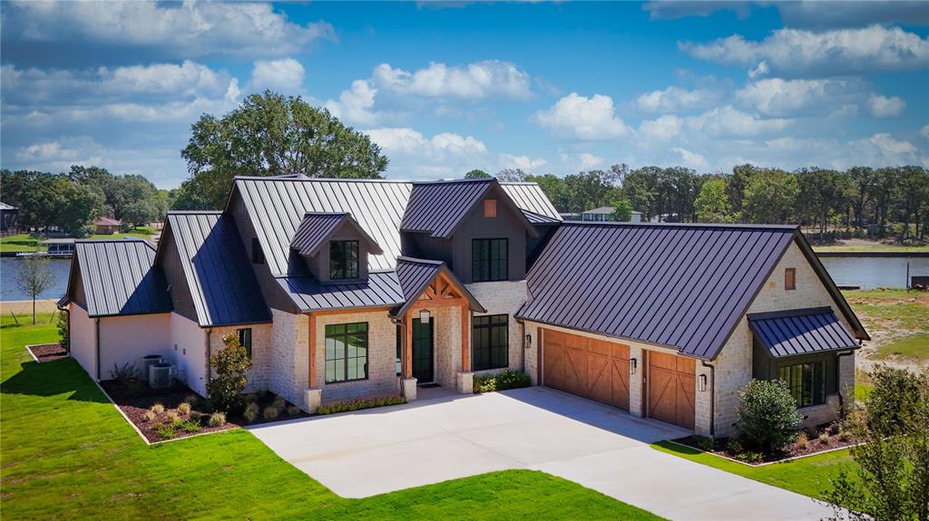Exquisite model home with 1000 + sq ft composite boat house now complete! The Groves at Cedar Creek Lake is a new 23 acre luxury gated waterfront community with deep water, fabulous water views and gorgeous sunrises. Built on one of the premier lots with cove protection, open water views and approx. 177 ft of waterfront at the wall. The finish out of this home is absolutely stunning and selected with ease of maintenance and durability in mind. Bonus room plus game room and built in bunk room! Lifetime warranty white oak engineered wood floor, Vadara quartz honed counter tops, custom cabinetry, Jenn Air appliances, and more. The spacious covered patio with outdoor kitchen, fireplace and heaters offer year round outdoor living. Plenty of room for a pool. Includes grass, landscaping, sprinkler system. Second home under construction with estimated completion September 2024. Lots available starting at 525K and more homes available starting at 1.8 million. New photos and website coming soon!