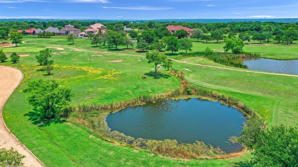Come build your dream custom home with Scott Post Homes on this stunning 1.13 acre golf course lot with a pond located in Eagle Chase near the Tanglewood Resort community. Minutes to new Margaritaville Resort location in Denison 2026. Enjoy your morning coffee on a 1100 square ft covered porch featuring a vaulted stained ceiling overlooking the golf course and private pond views! Full Custom, build this plan or design a new plan to make your perfect home. 6 month build time. Minutes to Lake Texoma and Highport Marina & the Island Bar & Grill. Retirement resort living at its finest only 55 minutes to Frisco, McKinney, & 25 minutes to Chocktaw Casino in Oklahoma. Beautiful surroundings full of deer & wildlife. Builder owns additional golf course lots. We have a low cost upgrade option for a whole house generator that most of our clients are including with their custom home builds, FYI. Come view our model home located in Gunter. SPECIAL LOW INTEREST RATE JUST LOWERED to 5.5% on our OTC loan program for our builds!