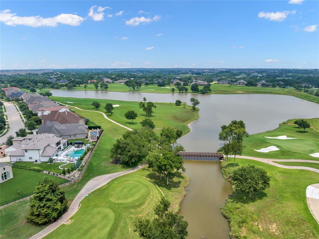 Epitome of luxury living on Gentle Creek Golf Course with stunning views of the 18th fairway, lake and 1st tee box. Unparalleled resort-style experience with 28,000-gallon pool, fire pits, putting green and outdoor kitchen. Step into an exquisite courtyard adorned with Italian pedestal pavers and fireplace. Interior harmonizes the open floor plan and light color palette with the captivating views. Kitchen highlights farmhouse sink, quartz countertops and luxury appliances including built-in refrigerator, commercial gas cooktop and double ovens. Secluded primary suite is a private refuge, furnished with custom built-ins that doubles as private office. Ensuite bathroom with separate vanities, freestanding tub, walk-in shower with dual heads and his and her closets. Casita off the courtyard with ensuite bathroom is perfect in-law quarters. Upstairs includes game room with picturesque balcony, media room and 3 guest bedrooms (2 ensuite). 3-car garage with epoxy floors.