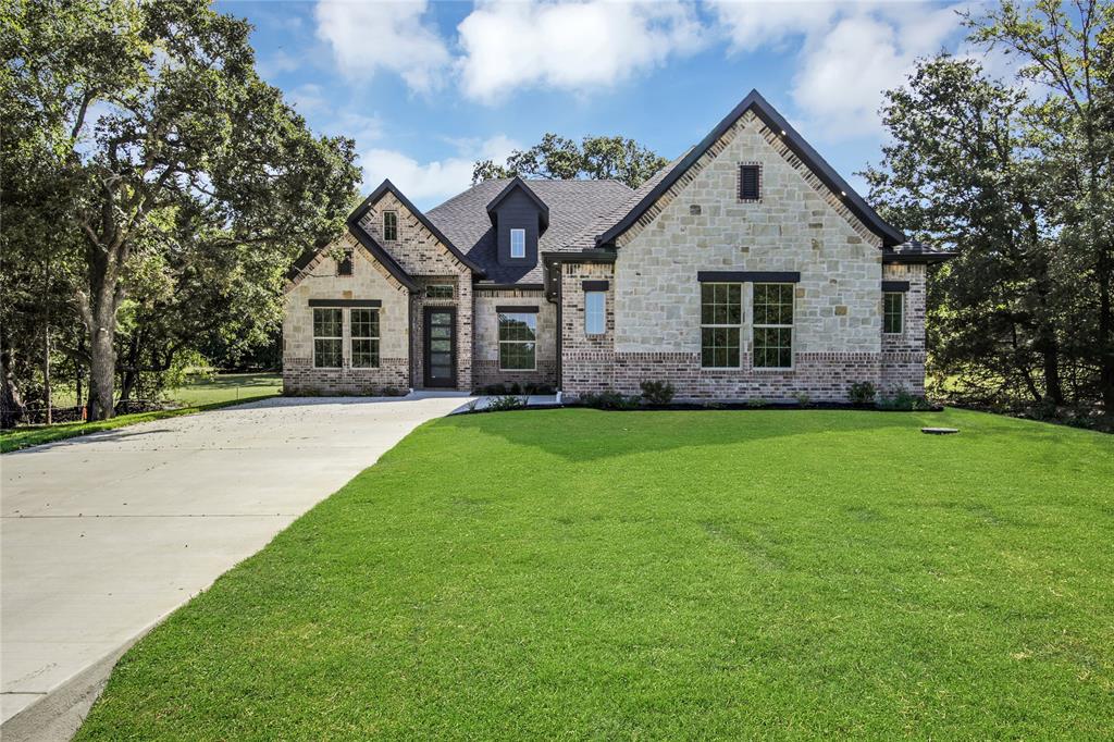 Welcome home to this custom one-story located in the private Lake Kiowa Community. Vaulted ceilings and white oak floors lead you into the open-concept space. A blend of modern and farmhouse crafts a sophisticated atmosphere. Discover a show-stopping gourmet kitchen with quartz countertops, white oak island, custom inset cabinets and top-of-the-line appliances. Your living space is centered with a floor-to-ceiling tiled fireplace and framed with built-in shelving. Unwind in luxury with a frameless glass shower, free-standing square tub, and floor-to-ceiling porcelain tile. Slip outside and enjoy your covered patio and brick fireplace. Find the peaceful and serene lifestyle in a rural setting you have been looking for. Lake Kiowa is 70 miles north of DFW, built around a 563 acre private lake offering various recreational activities. You'll find a clubhouse, restaurant, and other amenities for residents.