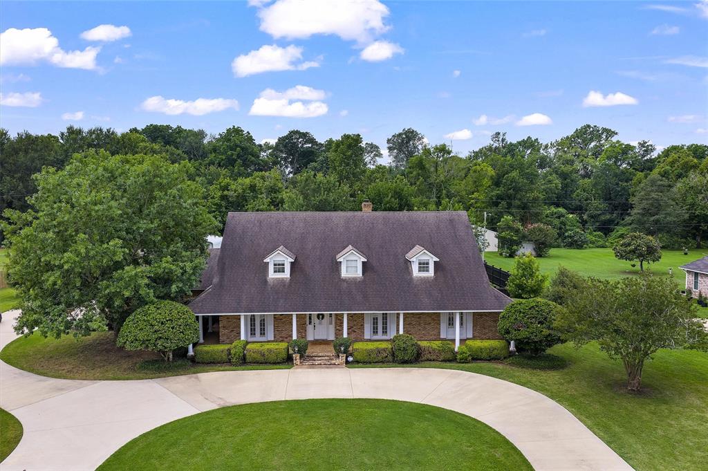 Welcome to your own private retreat on 1.5 beautiful acres.  Lovingly maintained by the same owners for the past 22 years, this exceptional property offers approximately 3,224 sq ft  of living space with 3 bedrooms, 2 full bathrooms, 2 half baths, and two versatile flex rooms currently used as a media room and an oversized primary closet.  Designed for entertaining, the expansive covered patio features a fully equipped outdoor kitchen with a grill, refrigerator, TV and electric shades overlooking a stunning 8 ft deep gunite pool.  
Additional highlights include a  20' x 30' climate controlled boat shed and an approximately 1100 sq ft guest house with 2 bedrooms, 1 full bath, large storage room and a spacious patio overlooking the bayou.
Complete with a monitored security system and surveillance cameras, this one of a kind property offers the perfect blend of privacy, comfort, and exceptional outdoor living.