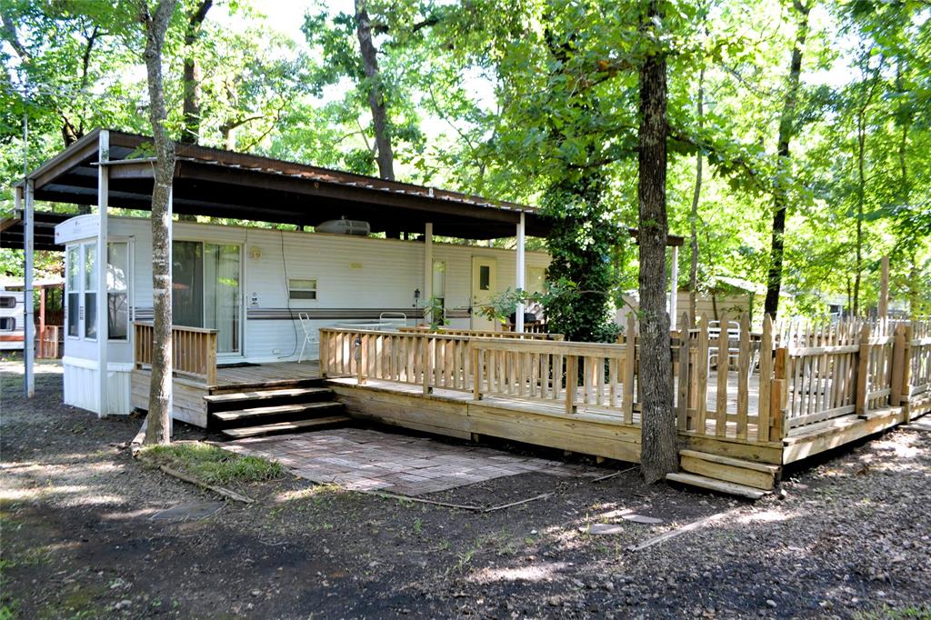 Lake Fork Getaway Ready for Immediate Enjoyment! Nestled within the gated community of Sun Eagle Bay, this turn key retreat is the perfect escape for fishing enthusiasts, weekend adventurers, or anyone looking to enjoy the relaxed East Texas lake lifestyle. Situated on three interior lots, the property includes a fully furnished 1993 Breckenridge Park Model, allowing you to start enjoying it from day one. The covered RV setup features a durable metal awning, spacious porch, and outdoor living area ideal for morning coffee, evening gatherings, or relaxing after a day on Lake Fork. There's plenty of room for boats, vehicles, and guests, plus an additional gravel pad ready for a second RV. Two storage buildings provide ample space for fishing equipment, tools, and outdoor gear. Sun Eagle Bay offers an impressive list of amenities including multiple boat ramps, fishing piers, swimming pools, playgrounds, and a community clubhouse. Whether you're chasing trophy bass, looking for a low maintenance vacation property, or seeking a place where family and friends can gather, this fully furnished lake retreat checks all the boxes. Bring your fishing poles, your boat, and your sense of adventure. Everything else is already here waiting for you.