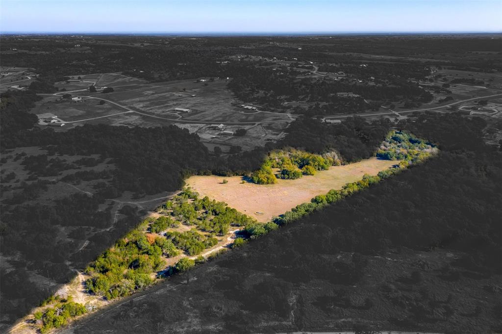 Discover 14 plus acres of pure potential, where nature's beauty unfolds. Towering trees offer shade and serenity, while expansive pastures stretch, waiting for your touch. This canvas is yours to build, create, and thrive – a harmonious blend of wooded privacy and open possibilities. Whether you envision a rustic cabin nestled among trees or a pastoral retreat, this land is your opportunity to sculpt your dreams. Embrace the tranquility of the land, the whispers of the wind through leaves, and the promise of a life well-lived on this diverse acreage.