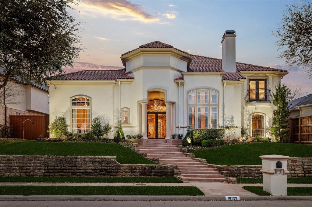 Tucked within the prestigious gated Oaktree enclave in North Dallas, featuring a guarded entrance and gatehouse, 18729 Wainsborough Lane blends timeless elegance with refined comfort in one of the area’s most desirable neighborhoods. This custom residence showcases soaring ceilings, rich hardwoods and travertine flooring, expansive living spaces, and an ideal layout designed for both entertaining and everyday living.

Featuring 5 spacious bedrooms, 4.5 baths, dual staircases, a wet bar, wine cooler, plantation shutters, and abundant natural light throughout, the home offers both sophistication and warmth. The chef’s kitchen flows seamlessly into the main living areas, while the oversized primary suite provides a true private retreat.

Step outside to a resort-style pool and beautifully landscaped backyard oasis, creating the perfect setting for relaxing evenings or hosting guests year-round. Situated on a beautifully maintained lot with a 3-car garage and located within highly sought-after Plano ISD, this exceptional home offers luxury living with convenient access to premier shopping, dining, and entertainment.