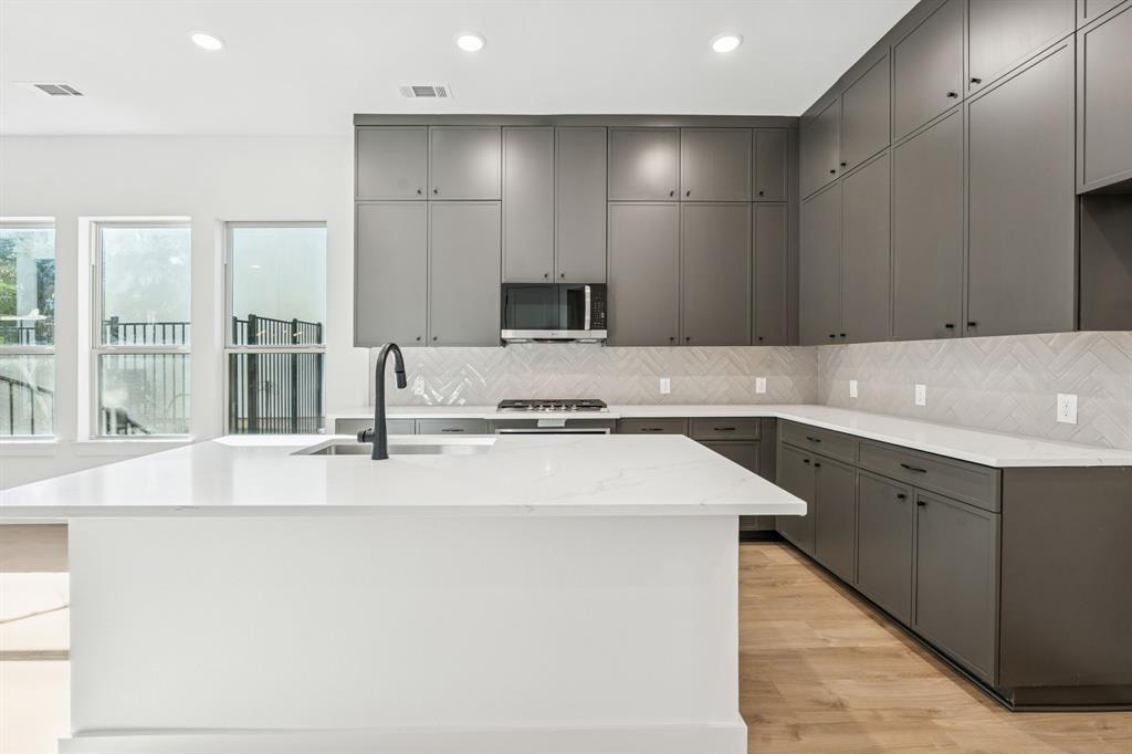 This property may be eligible for up to $10,000 in a Buyer Assistance down payment grant with builder's preferred lender! This is a great opportunity to make home ownership more affordable. Contact agent for more details. Located along the coveted shoreline of Lewisville Lake, Water’s Edge is a luxury, townhome-style, mid-rise condominium residence in Lake Dallas. Nestled amidst a perpetual forest of trees, you’ll discover an oasis of natural beauty with all the urban conveniences and entertainment close at hand. With magnificent lake views and a waterfront deck, you’ll love coming home to Water’s Edge. Final units are complete and ready for move in. Built by Crescent Estates, they offer 5 different floorplans ranging from 2087 square feet to 2372 square feet, 2 and 3 bedrooms plus game room, study and or loft. Residents also have access to lakefront clubhouse, fitness center & community pool. 428 Waterscape #1338 features the Englewood floorplan. Condos are Fannie Mae approved!
