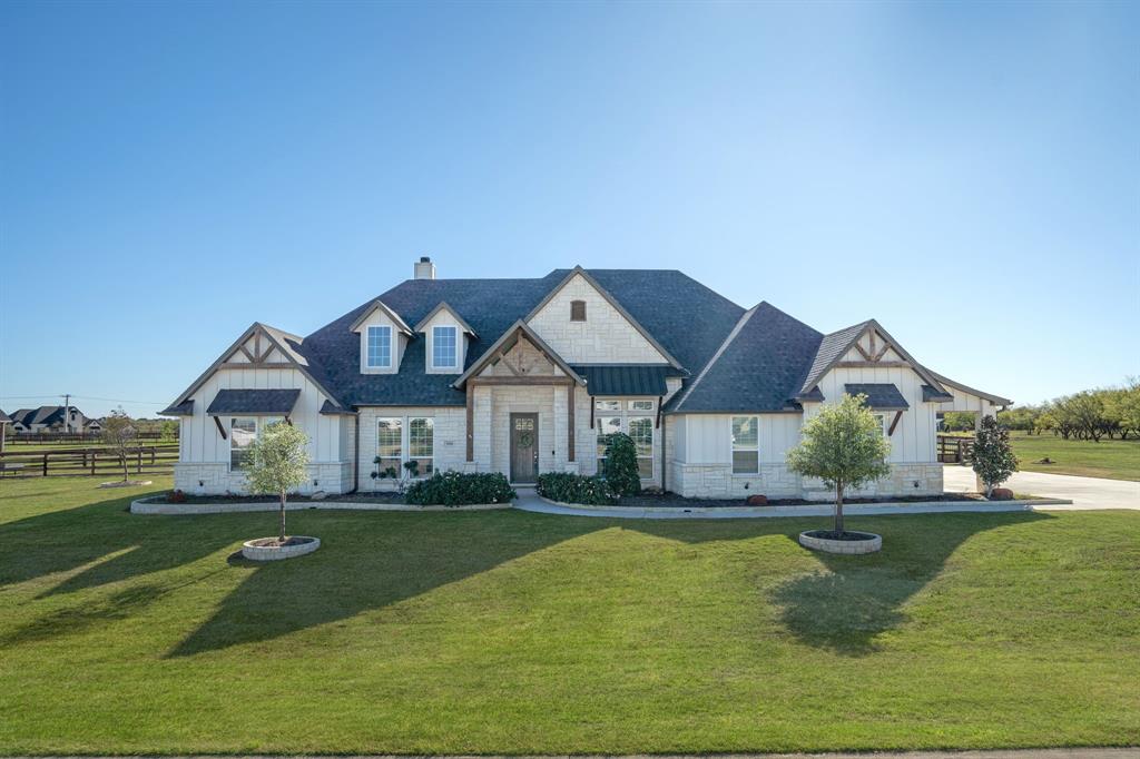 Embrace tranquility at Stardust Ranch! This lease offers a serene country lifestyle on an acre lot in a sought-after neighborhood zoned to Northwest ISD. Revel in the backyard paradise featuring a pool, outdoor living area with built-in grill and fireplace, relaxing sauna, and a putting green.This fantastic single-story home boasts 4 bedrooms, 3 baths, and a versatile game room that can double as a 5th bedroom. Step inside to experience the allure of handscraped wood floors, elegant plantation shutters, and decorative accent walls, imparting a custom-designed ambiance. The kitchen is a chef's dream with quartz counters, pot filler, farm sink, and top-notch appliances including a double oven. Unwind in the family room, highlighted by a wood-beamed ceiling and a striking floor-to-ceiling stone fireplace. Equipped with Tesla solar panels and a power wall battery tucked away in the spacious 3-car garage. This lease offers the perfect blend of luxury and comfort in a picturesque setting.
