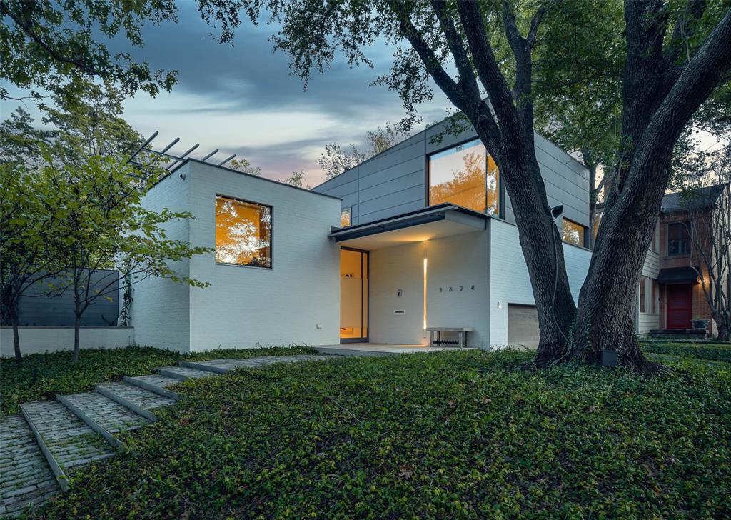 Designed in 2016 by celebrated Dallas architect Max Levy, this contemporary home is situated on a lush lot with mature trees and foliage in the sought-after Turtle Creek neighborhood of Northern Hills. The 3,573-square-foot residence features artful touches and tailored details throughout, including adjustable lighting, a custom art-installation system, a handsome open-concept kitchen, and a tranquil courtyard and pool. The one-and-a-half-story home built by Steve McCombs also boasts three bedrooms, two-and-a-half baths, a study, and a two-car garage. The primary suite features his-and-hers bathrooms, a shared space accented with hand-painted Gracie wallpaper and a soaking tub, a built-in vanity, and storage.