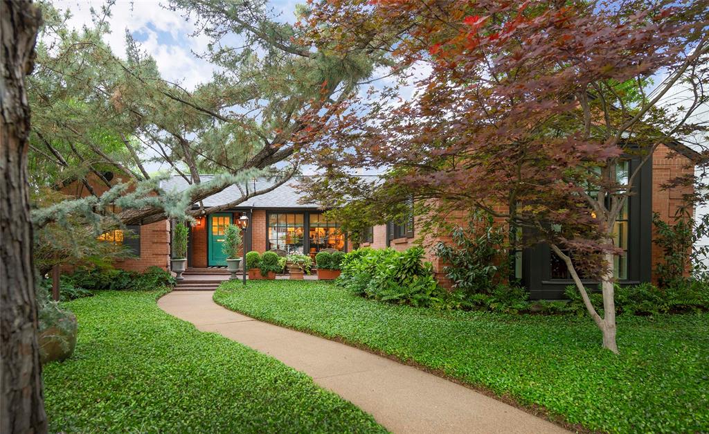 Tucked into a lush, park-like setting on a coveted 60’ corner lot, this enchanting 1930s cottage, designed by Lucius E. O'Bannon, is a true jewel box in the heart Highland Park. Thoughtfully updated while preserving its timeless charm, the home is surrounded by exquisite grounds designed by renowned landscape architect Robert Bellamy—where intimate courtyards, tranquil fountains, and layered greenery create a sense of privacy and serenity rarely found.

Inside, rich hardwoods and abundant natural light set the tone. Floor-to-ceiling windows frame verdant views from every room, blurring the line between indoors and out. The interiors are both refined and inviting, with curated materials including honed Jura Beige limestone countertops and slab backsplash in the kitchen, a honed French limestone hearth, and a beautifully appointed primary bath finished in statuary white and Ann Sacks basketweave marble.

Every detail has been considered—from double-pane windows and integrated sound system to iconic Bevolo lanterns and a custom iron gate leading to the secluded backyard retreat. Each space feels intimate yet elevated, designed for both quiet living and gracious entertaining.

Perfectly positioned just moments from Highland Park Village and Fairfax Park, and zoned to highly sought-after Bradfield Elementary, this one-of-a-kind residence offers rare privacy, timeless elegance, and an effortless connection to nature—an exceptional offering for the discerning buyer.
