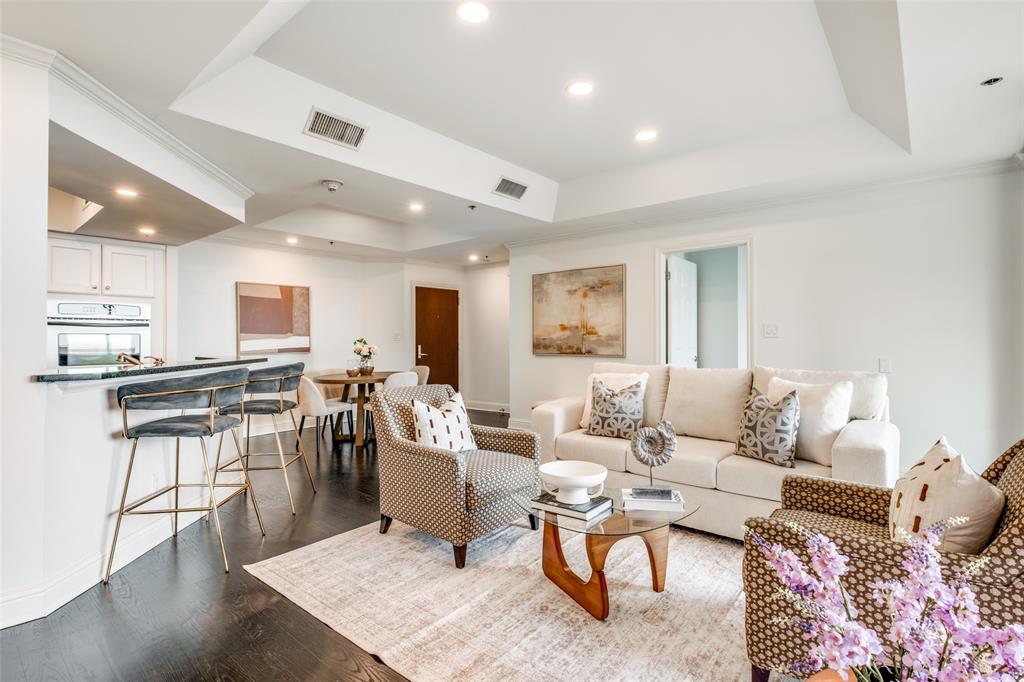 Rising high above Preston Center, this 10th-floor residence at The Shelton offers the perfect blend of high-end style and lock-and-leave convenience in the heart of Dallas. Located within the coveted Highland Park ISD, the home opens into a bright, airy floor plan highlighted by rich hardwood floors, updated finishes, and floor-to-ceiling windows with panoramic views. The open-concept kitchen is ready for entertaining with stone countertops, a built-in wine refrigerator, and premium stainless steel appliances, while the private covered balcony serves as your own front-row seat to the Preston Hollow skyline. The split-bedroom layout ensures maximum privacy, featuring a primary suite sanctuary with a marble-clad spa bath, a deep soaking tub, and a custom walk-in closet with professional built-in organization. Residents receive the full resort treatment with valet and concierge service, a heated rooftop pool with private cabanas, a professional fitness center, and a sky-high putting green. Whether you're walking to dinner at local Preston Center hotspots or enjoying the peace of a modern home with a designer guest suite, this condo delivers an upscale urban lifestyle that’s hard to beat.
