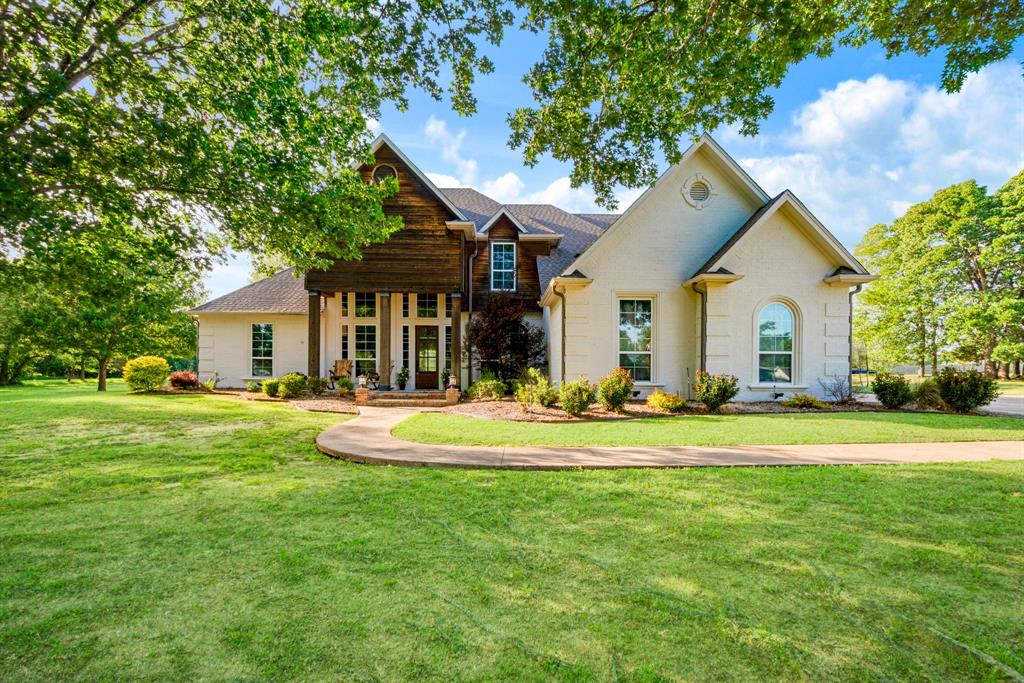 Welcome to this stunning 5 Bedroom, 3.5 bath home located in the sought after Stone Ridge Estates, just off 195 close to the Paris Golf and Country Club! Spanning over 3700 square ft on a generous 2.26 acres lot, this residence features vaulted ceilings and an inviting entry with gorgeous staircase.  The chef's kitchen is designed for culinary enthusiasts that enjoy entertaining and opens to light filled rooms that enhance the homes spacious feel.  Additional highlights include a covered patio, sprinkler system and hand scraped hardwood floors.  The property also boasts a three car garage and a circular drive with a covered porte cochere for added convenience.  Situated within the North Lamar ISD, this home offers both comfort, space and accessibility in an attractive neighborhood!