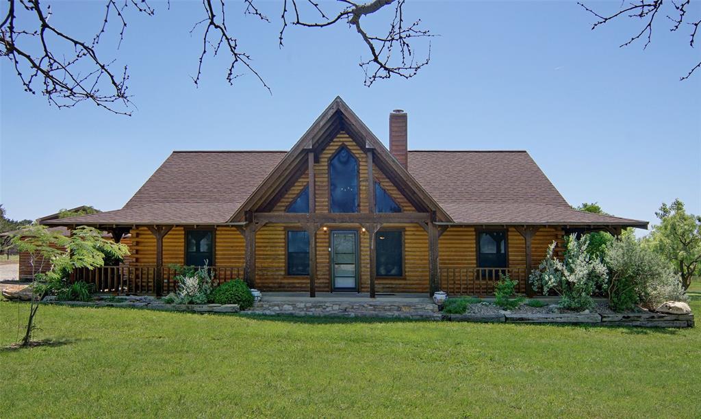 Get away from the hustle and bustle of city life at The Hills Above Possum Kingdom. This tranquil retreat is situated on a well manicured 4.9-acre property. The Charming log home offers three bedrooms, a bunkroom and two baths as well as a nice private and covered back patio for grilling, lounging or taking in the sounds of nature that surround you. You will delight in the outdoors where the sweat equity has already been invested, boasting a new 30 x 40 pull thru RV garage - shop or storage for all of your lake toys. For those with a passion for horses, a traditional three-head stall barn with a well-equipped tack room, and convenient storage. Newly built and painted pipe and non climb fence surrounds the rear portion of the property. The entire property, has seeded in fescue and coastal Bermuda. The property's crown jewel is a charming newly built+- .5 acre pond, perfect for relaxing by the water's edge or enjoying peaceful moments in nature. Don't miss this opportunity to own a piece of paradise in a tranquil country community just off the north end of Possum Kingdom Lake with ample space for privacy and outdoor activities. Amenities include gorgeous infinity edge pool, clubhouse with foosball, pool table, and well equipped gym. Ritchie Cabin located at the community boat ramp and courtesy dock i