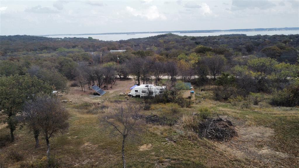 Escape the hustle and bustle of the city. This beautiful wooded .218 acre lot is just waiting for you to show up with your own builder and house plans or install a MF home on it. No HOA here, just kick back and relax in the peaceful surroundings of Runaway Bay. Plan to visit soon!