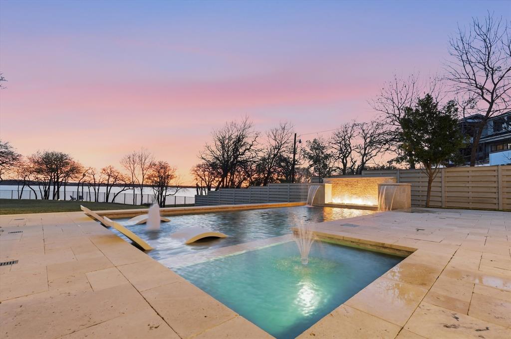 ***RARE WATERFRONT LUXURY at its FINEST on LAKE GRAPEVINE! This is your UNICORN! Welcome to this stunning and FLAWLESS Beach Custom Home perfectly situated on a private HALF-ACRE unobstructed LAKEFRONT AND ONLY WALKABLE BEACHFRONT property in Denton County. This gorgeous property is the epitome of luxury living, offering the best of both worlds—a primary residence and vacation lake house all-in-one w NO HOA and still under builders warranty!
Step into a lifestyle where every day feels like a retreat. Imagine waking up in approx. 4300sf of luxurious breathtaking water views, stepping directly onto the sandy shoreline, and enjoying the serenity of one of Texas’ most premier lakes—all from the heart of Flower Mound, recently named the #1 Best Small Town to Live in the U.S. (Forbes & Livability, 2025).
This 4bed, 5bath fully AI automated, smart home blends modern elegance with lakefront charm, featuring expansive open-concept living, vaulted ceilings, designer finishes, and fully expanding glass pocket doors framing panoramic lake views including a custom pool, spa and decking designed by award winning design firm, Claffey Pools. This is an entertainers paradise! Each bedroom has their own private ensuite bathroom, including an exclusive mother-in-law suite. The private half-acre lot provides endless opportunities for outdoor living—from entertaining lakeside, launching water adventures, or relaxing under the breathtaking Texas sunsets 365 days a year. 
Located in one of the most sought-after and award-winning school districts and the #1 HS in LISD—making it a perfect choice for families seeking excellence in education. With DFW International Airport just 15 min away and only 20min to Dallas or Ft Worth, convenience and accessibility to 121, 35 are unmatched.
Whether you’re seeking your forever residence, a private lake retreat, or both, it delivers the ultimate blend of sophistication, comfort, and waterfront living.
Don’t miss this once-in-a-lifetime opportunity!