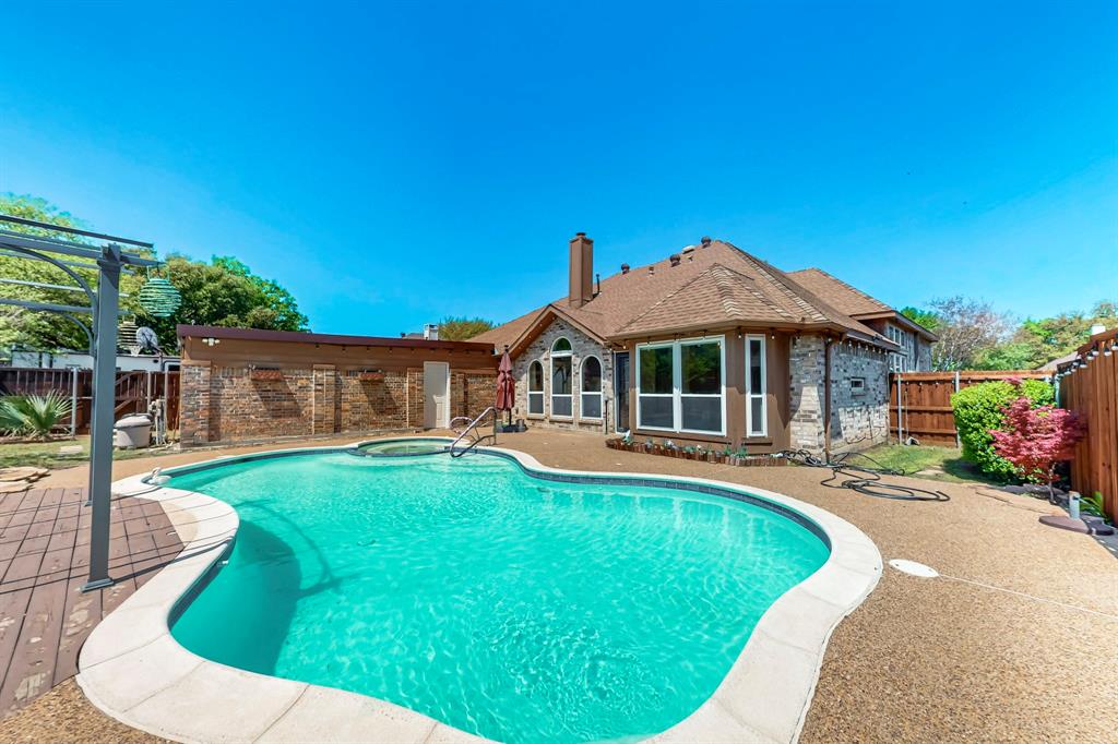 SELLER OFFERING $5,000 CREDIT IF HOME CLOSES BY JULY 22, 2026.
Brand new $28,000 roof was just installed. 
This fabulous three-bedroom home boasts incredible curb appeal and a thoughtfully designed floor plan. Just off the entry, a formal living room offers the perfect space for intimate gatherings. A spacious dining room, highlighted by a wall of windows, invites natural light to flood the space. Elegant travertine tile floors flow throughout the home, enhancing its timeless charm. The expansive living room features a built-in corner cabinet for storage, a cozy brick fireplace, and breathtaking views of the backyard oasis. The gourmet kitchen is a chef’s dream, complete with dual islands, sleek granite countertops, a tumbled stone backsplash, a gas cooktop, and stainless steel appliances. A charming breakfast nook provides the perfect spot for casual dining. The generously sized primary suite is a true retreat, offering an en-suite bath with luxurious upgrades. Two additional guest bedrooms share a fully remodeled bathroom with $10K in updates! A first-floor game or media room, complete with a built-in dry bar, is ideal for entertaining or family movie nights. Step outside to an easy-to-maintain backyard, where a massive patio surrounds a sparkling pool and spa—your own private paradise!