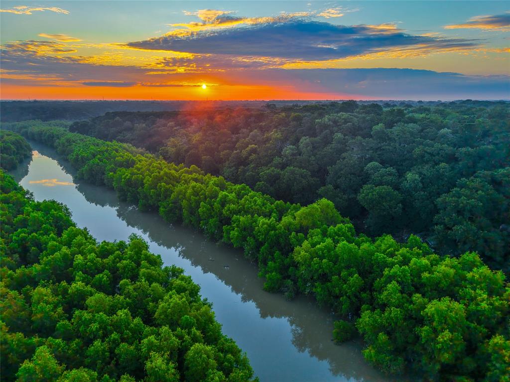 Located in Bell County near the upper end of Lake Belton, Wildlife Ridge is a 61.9+- acre property that offers a combination of residential improvements, recreational opportunities, and wildlife habitat. The property includes a custom Austin stone home, a large shop with utilities, and access to the Leon River through adjacent Corps of Engineers land. The home is positioned to provide views of the surrounding acreage while maintaining privacy from neighboring properties. A 40x50 shop on a concrete slab is located near the home and is equipped with electricity and a rainwater collection system. The combination of residential and utility improvements supports a variety of uses including agricultural operations, outdoor recreation, or rural living. The acreage includes a mix of open areas and wooded cover that create habitat for native wildlife. Deer, turkey, raccoons, and hogs are commonly observed on the property. A wildlife tax exemption keeps the property taxes at a very reasonable rate. The terrain supports hunting and outdoor recreational activities while also offering areas suitable for trail riding, hiking, or wildlife observation. One of the notable features of the property is access to the Leon River through neighboring Corps of Engineers land. This access provides additional opportunities for fishing, kayaking, and exploring the river corridor. Buyers should independently verify access rights and permitted uses with the appropriate authorities. The property is located approximately: 8 miles from Moody, 20 miles from Temple, 24 miles from Belton, 28 miles from Waco and 70 miles from Austin.  This Bell County property may appeal to buyers seeking recreational land with residential improvements, hunting opportunities, and access to outdoor activities. The combination of acreage, wildlife habitat, utility improvements, and proximity to nearby towns supports a variety of potential uses. Owner financing is available.