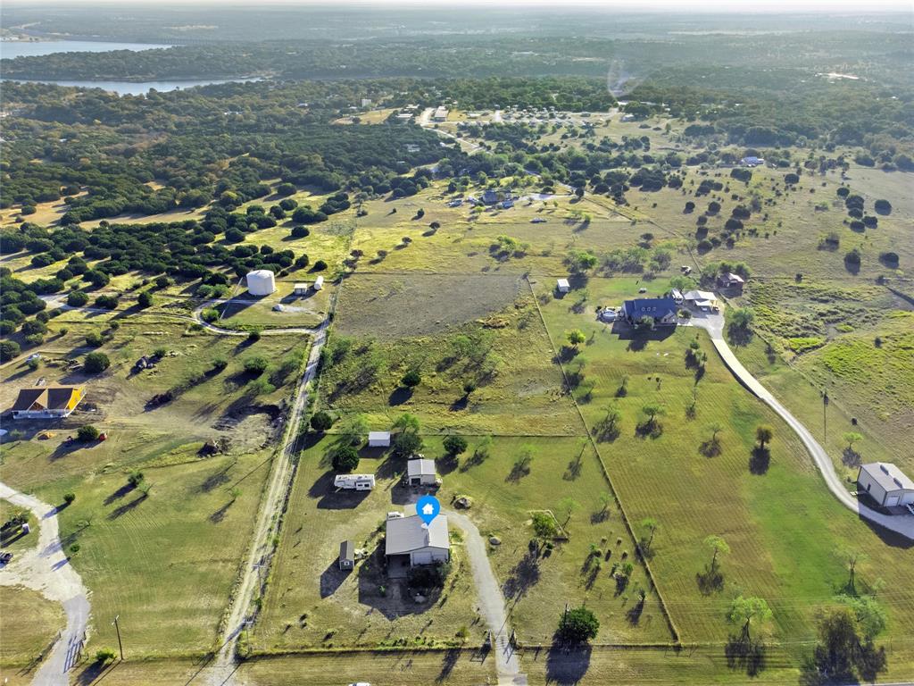 Discover your serene getaway on 5 acres of picturesque land, just moments from the beautiful Lake Whitney. This unique home includes a metal shop with electricity connected! Don't forget the metal shed and a large carport big enough to fit an RV making it the perfect retreat for relaxation or adventure. Whether you seek a permanent residence or a weekend escape, this property near Lake Whitney and Laguna Park is the ideal spot to unwind and enjoy the beauty of the great outdoors. Don’t miss out on this incredible opportunity!