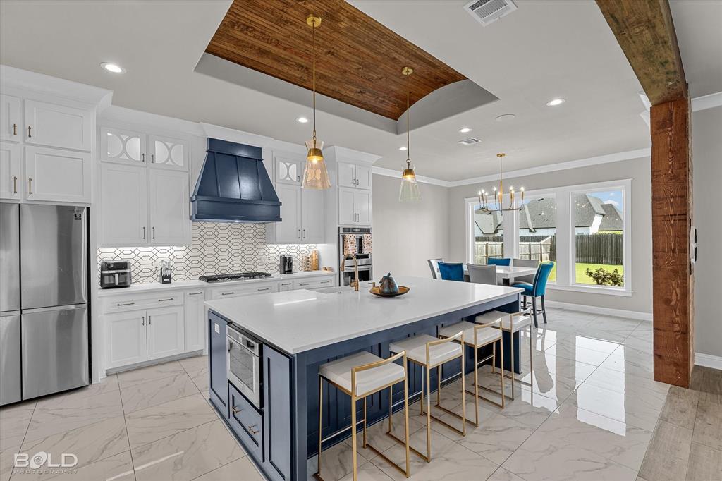 Experience Luxury Living in the Heart of North Bossier!
Located in the sought-after Canal Place Subdivision, this stunning residence is one of the largest homes in the community—where elegance, comfort, and craftsmanship blend seamlessly. Calling this home a “dream home” is truly an understatement. Every inch of this masterpiece was built with love, intention, and a passion for luxury living.  From the moment you step inside, you’ll be captivated by the beautiful marble flooring in select areas, designer lighting fixtures, and quartz finishes that flow throughout the home. The chef’s kitchen is a showstopper—featuring breathtaking design, top-tier finishes, and space to entertain in true style.  The open-concept living areas and bar space make this home perfect for hosting gatherings, while the outdoor patio and grill area are ideal for cheering on your favorite team or relaxing with family. With a spacious backyard offering endless potential—including room to build your dream pool—the possibilities are endless.  Retreat to the primary suite, a true work of art with exquisite design details, a spa-inspired bathroom, and a tranquil ambiance that redefines relaxation. The upstairs living or game room provides even more flexibility for your lifestyle needs.  Additional highlights include a 3-car garage, tray ceiling designs, and a modern color palette that enhances every room’s elegance. Perfectly situated between Benton Road and Airline Drive, this home offers easy access to top-rated schools, shopping, restaurants, and medical centers—everything you need is just minutes away.  Words can’t truly capture the beauty and sophistication of this property—come see it for yourself and fall in love with what could be not just your dream home, but your forever home.