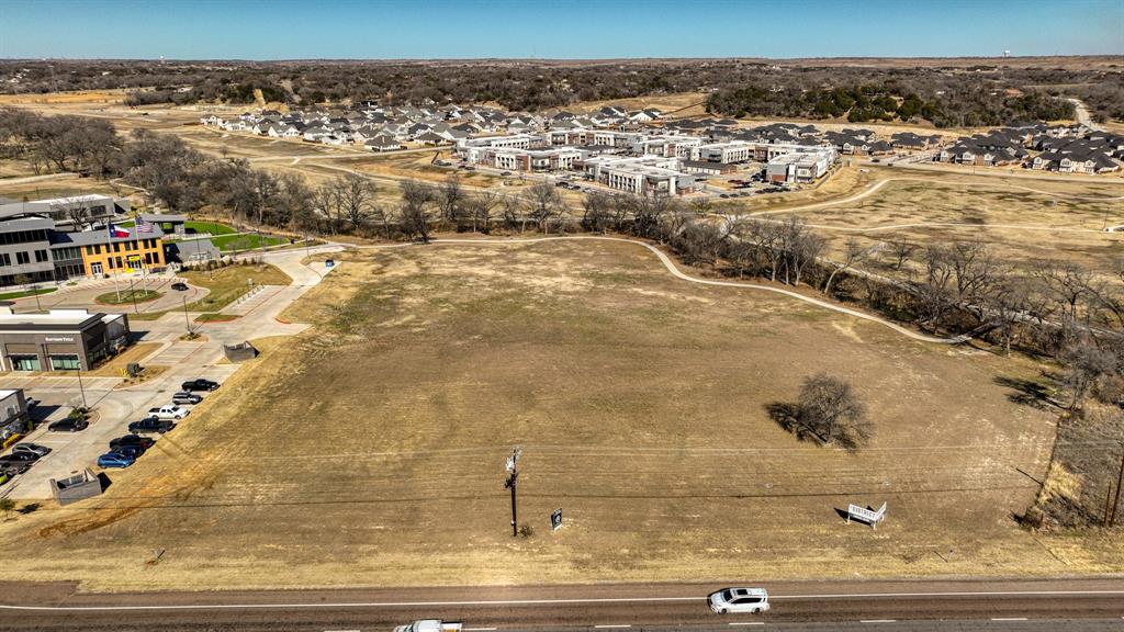 Prime Commercial Lot in the Heart of Willow Park. This exceptional 3.83-acre commercial tract offers a rare opportunity in the rapidly growing Willow Park area.  Direct frontage on IH20 and the service road, the property is perfectly positioned adjacent to The Shops at Willow Park, The District and the emerging Crown Pointe Commercial Area. With high visibility from all directions, this prime location is surrounded by major development, including a luxury boutique housing. The open pad site provides an ideal setting for a restaurant, retail space, or office facility. Don’t miss this opportunity to establish your business in a premier location with endless potential.