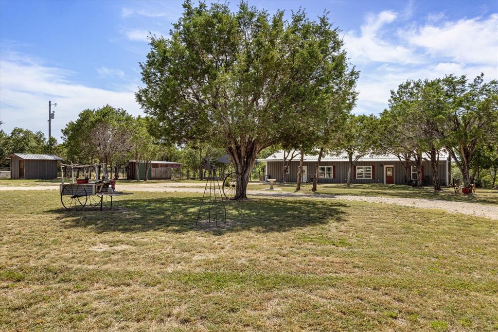 Step back and enjoy the entertainment of having 2 acres, with no neighbors close to you! Tree's all over for privacy, deer run through, turkeys run through the ranch that back up to you! Set on the new amazingly large screened in back porch and cookout! So many updates here and wow, a massive pine game room, man cave, office, business and or make easily into a guest house! New huge 2 car carport, circle drive and so much parking here, new fencing and gates for privacy! Storm shelter master closet is huge, very expensive generator system, so if everyone around you looses electricity you will not! The shop is a mans dream, 220V, a couple of separate rooms for welding, painting and whatever your business needs! Close to town, but far enough down the CR you don't realize!