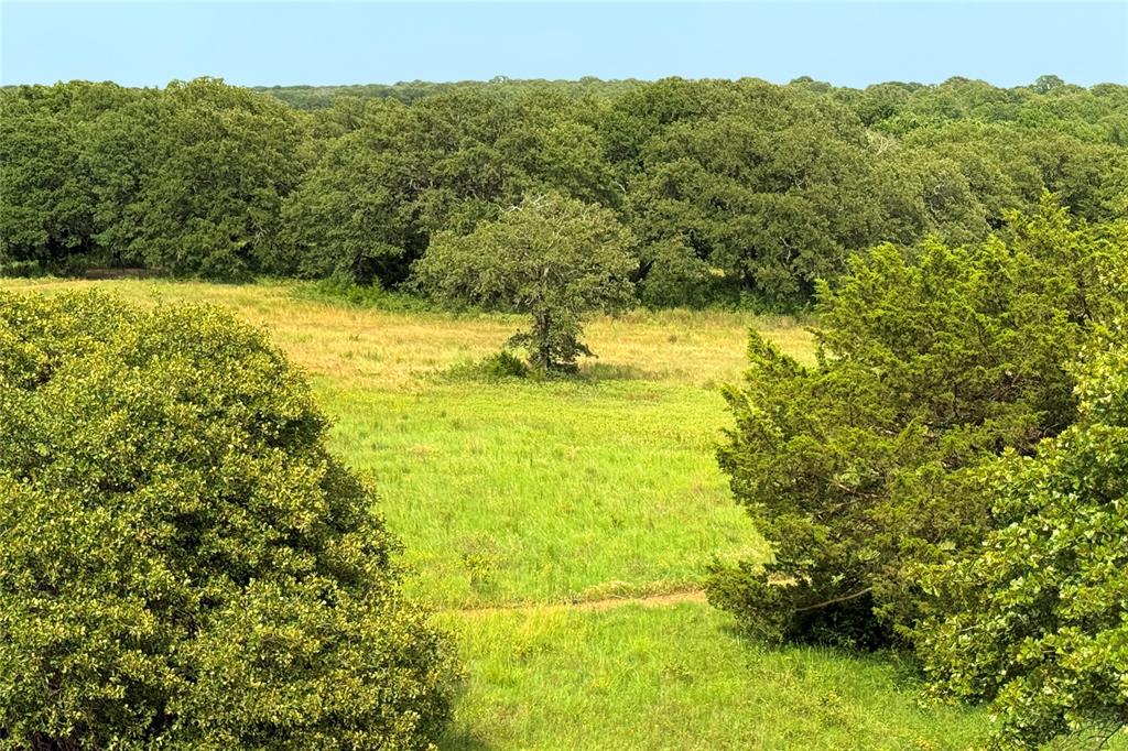 Welcome to your own private retreat located just 45 minutes north of downtown Dallas. Spanning 16.7 acres, this property offers breathtaking hilltop building sites, perfect for your custom dream home with scenic views of lush pastures and wooded areas. The property also has a custom-built barndominium featuring a versatile unfinished first floor that could be tailored for your needs with a spacious second-floor residence that boasts an open floor plan perfect for entertaining family or guests, including a vaulted living room, four comfortable bedroom suites, a large kitchen, dining area, and a master suite with office. A charming bunkhouse boasts a massive deck that feels like a tranquil tree house. The property is home to abundant native wildlife, and excellent fishing opportunities await at nearby Lake Ray Roberts. Explore the natural beauty of Isle du Bois State Park, which offers biking, hiking, and horseback riding trails. All this is just minutes away from the delightful historic downtown Pilot Point. Aubrey or Pilot Point ISD. To maintain the area's integrity, the property is lightly deed restricted. Wildlife exemption offering lower property taxes. See supplement documents for proposed restrictions.