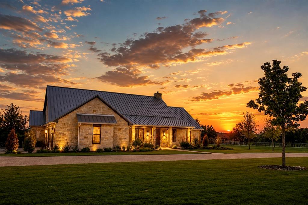 Experience refined Texas luxury in this extensively redesigned custom estate nestled on nearly 6 private acres within the prestigious gated community of Silverado on the Brazos. Thoughtfully reimagine with exceptional quality, timeless design and upscale comfort in mind, this stunning 4-bedroom, 3 bath residence offers approximately 3296 square feet of sophisticated living. When you enter, you are greeted by soaring vaulted ceilings, rich architectural elements, decorative lighting, and expansive open concept living spaces designed to blend warmth and elegance. The chef's kitchen features premium finishes, a large island with granite countertops, gas cooktop, double ovens, custom cabinetry, and seamless flow into the spacious living and dining areas. Luxury continues into the private primary retreat featuring a spa inspired ensuite bath complete with a beautiful soaking tub, upscale finishes, and a serene atmosphere designed for relaxation. The oversized steel framed glass doors open to an expansive covered outdoor living area, creating a seamless indoor-outdoor experience. This property also boasts an exceptional entertainment barn shop designed with versatility and hospitality in mind. Complete with a guest apartment, this incredible space offers endless possibilities for hosting guests or creating a private retreat. It includes roll up doors, concrete drive access, multiple 50-amp RV hookups, sewer disposal connections, and ample room for recreational vehicles, with room for future expansion. Built with efficiency in mind, the home includes foam insulation, 2x6 exterior walls, tankless water heaters, generator, well house and high-end construction features throughout. The layout and acreage also provide excellent potential for equestrian improvements including a small horse barn and-or turnouts, making this property ideal for luxury living with flexibility and function. This is more than a home; it's a private lifestyle property where design meets ranch elegance.