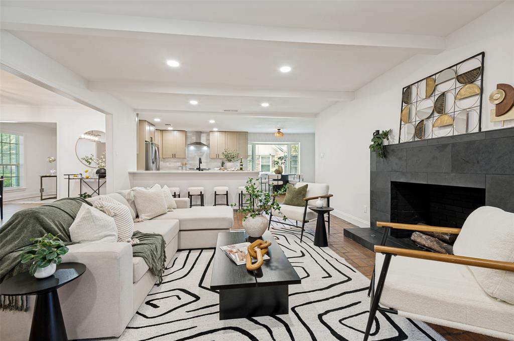 Completely updated from top to bottom, this exceptional Richardson ISD home blends timeless design with a highly functional floor plan in the sought-after Lake Highlands area of Dallas. From the moment you enter, you're welcomed into an expansive living room where a dramatic, moody fireplace serves as the centerpiece, creating a warm and inviting space for gathering and entertaining. The fully renovated kitchen is equally impressive, featuring updated cabinetry, countertops, appliances, a gas range, refrigerator included, an oversized walk-in pantry, and a breakfast area. Just beyond, the spacious laundry room offers even more storage, while generous closets throughout the home provide exceptional organization. Overlooking the sparkling in-ground pool, the oversized flex room can easily serve as a game room, playroom, fitness studio, or creative space. Additional living spaces include a dedicated formal dining room and a home office. One of the home's most desirable features is its thoughtfully designed first-floor layout, offering both the primary suite and a secondary bedroom, each with its own private ensuite bath. Whether used for multigenerational living, a guest suite, or nursery, this rare configuration offers exceptional functionality. Upstairs, you'll find two generously sized bedrooms connected by a Jack-and-Jill bathroom. With beautifully renovated bathrooms, a private attached two-car garage, and quick access to I-635, US-75, NorthPark Center, White Rock Lake, Downtown Dallas, shopping, dining, and major employment centers throughout DFW, this move-in-ready home offers the perfect blend of style, functionality, and location.