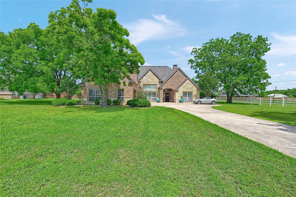 Seller offering $5000 towards buyer closing costs!! Welcome to 30 Tananger Springs Drive, a stunning custom-built retreat tucked inside one of Denison’s premier gated communities. Situated on a sprawling 1-acre lot, this home offers unmatched privacy and luxury in a serene setting. With over 3,000 square feet of living space, this 4-bedroom, 3.5-bathroom residence blends thoughtful design with exceptional comfort. Inside, you'll find an open-concept layout that seamlessly connects the living, dining, and kitchen areas—perfect for both everyday living and entertaining. Rich hardwood floors add warmth and elegance, while a striking floor-to-ceiling brick fireplace anchors the living space. The kitchen is the heart of the home, featuring custom cabinetry, ample counter space, and high-end finishes throughout. The oversized primary suite is a true retreat, complete with its own fireplace, spa-like en suite bath with dual sinks, jetted tub, separate shower, and a large walk-in closet. Secondary bedrooms are generously sized and split from the primary for added privacy. Upstairs, a spacious bonus room with a built-in bar offers endless possibilities—ideal as a guest suite, game room, or media space. Step outside to your own private paradise. The backyard is an entertainer’s dream with a sparkling pool and spa, covered pergola, and expansive green space—perfect for relaxing or hosting gatherings year-round. The 3-car garage provides plenty of room for vehicles and storage, rounding out this incredible property. If you're looking for luxury, privacy, and a true sense of home, 30 Tananger Springs Drive delivers it all!