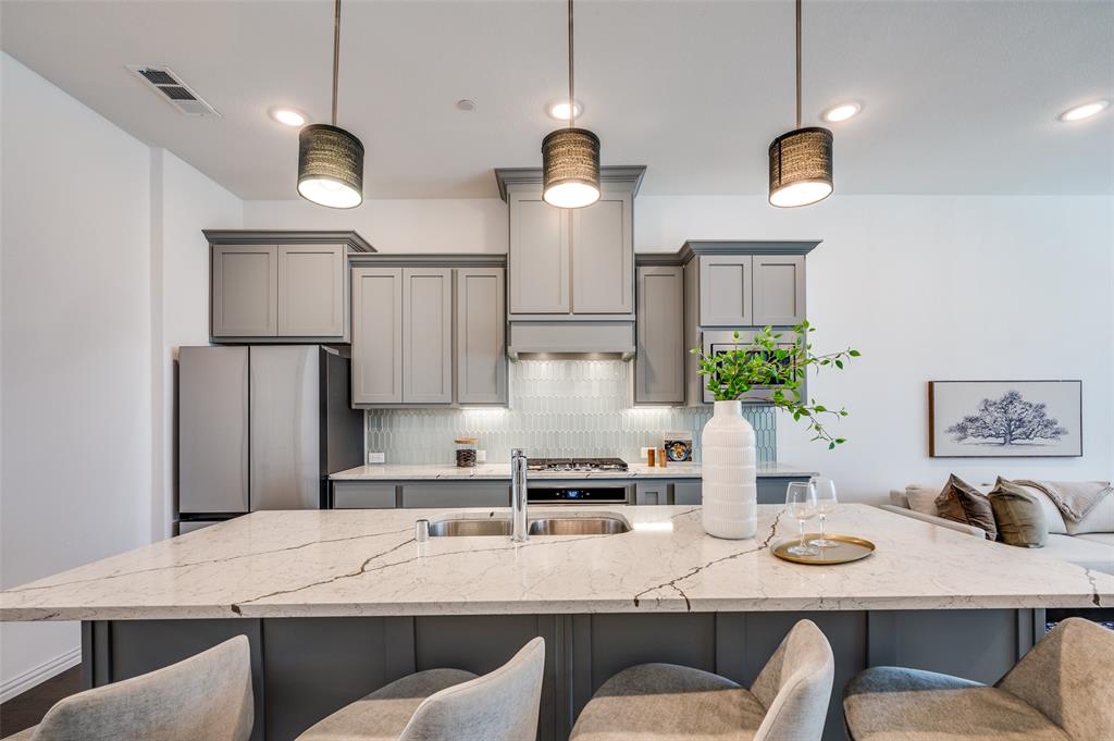 Wake up to soft morning sun, peaceful courtyard views, and a lifestyle designed around nature and walkability. Located on the island in Viridian, 3718 Pelican Rest offers a rare sense of calm just steps from the lake, trails, and preserved green space.

This three-level townhome features a flexible and functional layout. The first floor includes a private bedroom with en-suite bath and walk-in closet—ideal for guests, a home office, or multigenerational living—set against tranquil garden views.

The second floor is filled with natural morning light and offers an open-concept kitchen, dining, and living space that flows effortlessly for everyday living and entertaining. A convenient half bath is also located on this level.

Upstairs, the primary suite overlooks the beautifully maintained courtyard, creating a quiet retreat at the end of the day. A secondary bedroom with its own en-suite bath completes the third level, offering comfort and privacy throughout the home.

Just a two-minute walk from the front door, enjoy lakeside seating, scenic trails, and the natural surroundings that make Viridian one of North Texas’ most distinctive communities. Designed with conservation in mind, Viridian blends wetlands, lakes, and open green space with resort-style amenities including pools (with an adult-only option), tennis and pickleball courts, a sailing center, parks, and year-round community events.

Ideally located minutes from DFW Airport and positioned between Dallas and Fort Worth, this home offers the perfect balance of peaceful living and everyday convenience. Thoughtfully situated, light-filled, and surrounded by nature—3718 Pelican Rest is island living at its best.
