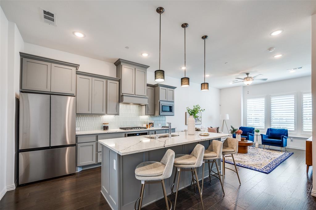 Wake up to soft morning sun, peaceful courtyard views, and a lifestyle designed around nature and walkability. Located on the island in Viridian, 3718 Pelican Rest offers a rare sense of calm just steps from the lake, trails, and preserved green space.

This three-level townhome features a flexible and functional layout. The first floor includes a private bedroom with en-suite bath and walk-in closet—ideal for guests, a home office, or multigenerational living—set against tranquil garden views.

The second floor is filled with natural morning light and offers an open-concept kitchen, dining, and living space that flows effortlessly for everyday living and entertaining. A convenient half bath is also located on this level.

Upstairs, the primary suite overlooks the beautifully maintained courtyard, creating a quiet retreat at the end of the day. A secondary bedroom with its own en-suite bath completes the third level, offering comfort and privacy throughout the home.

Just a two-minute walk from the front door, enjoy lakeside seating, scenic trails, and the natural surroundings that make Viridian one of North Texas’ most distinctive communities. Designed with conservation in mind, Viridian blends wetlands, lakes, and open green space with resort-style amenities including pools (with an adult-only option), tennis and pickleball courts, a sailing center, parks, and year-round community events.

Ideally located minutes from DFW Airport and positioned between Dallas and Fort Worth, this home offers the perfect balance of peaceful living and everyday convenience. Thoughtfully situated, light-filled, and surrounded by nature—3718 Pelican Rest is island living at its best.