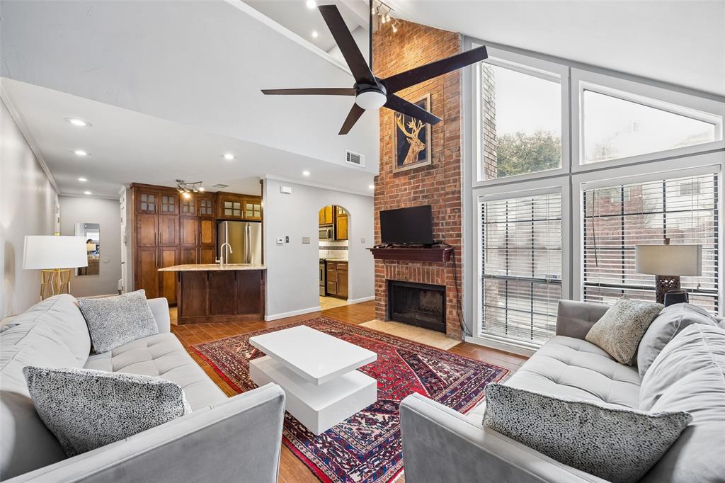 Beautifully updated, 1 Bed + 1.5 Bath, two-story condo with vaulted ceilings and wood style flooring in convenient location with pool, hot tub, and tennis courts! Recently updated, open and airy condo boasts a charming patio, perfect for outdoor grilling and relaxation, large windows that flood the space with natural light, and floor-to-ceiling brick wood-burning fireplace. Kitchen offers granite countertops, stainless steel appliances with newer refrigerator included, an electric cooktop and oven, and breakfast bar overlooking the living room area. Downstairs half-bath with granite counter top and full size washer & dryer included. Second floor loft bedroom includes an en-suite bathroom with newly updated, glass-enclosed shower, tub, and large walk-in closet. Very quiet townhome style corner unit, this unit does not have any neighbors above or below! Enjoy community amenities, a sparkling pool with hot tub and lounge area and tennis court! Great location, close to President George Bush Turnpike, Dallas North Tollway, great shopping, lots of restaurants and close to airports. Commuter-friendly and conveniently located for a well-connected and hassle-free lifestyle. 2 designated parking spaces for the unit + carport! HOA Dues include Water, Sewer, and Trash. See this property today!