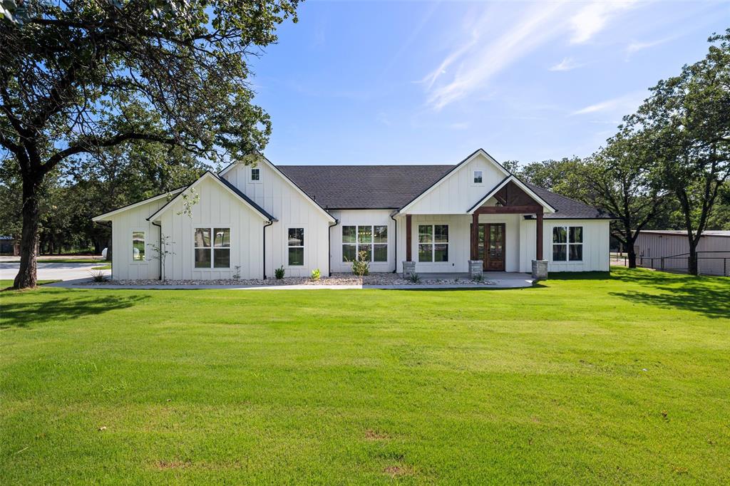 CHARMING MODERN FARMHOUSE in the country nestled among tall oak trees. This comfortable farm style home, centered on 1.76 acres, with plenty of elbow room for pets, a horse, chickens, garden, and pool, is designed for entertaining and everyday living. Inviting front porch. Boasting an array of sleek finishes and open layout. Beautiful stone fireplace and engineered wood flooring. The gourmet kitchen features handsome knotty alder cabinets, granite, SS appliances, gas cooktop and huge pantry. Adjoining dining room has great views. Roomy walk-in shower & slipper tub in primary bath. Split bedrooms. House and garage fully foam-insulated. Storage barn-workshop out back. Concrete driveway from street to garage with lots of parking area. Pipe fence on front with electronic gate opener. Property has its own new well. Sprinkler system and new sod. RV hookup. Place to hook up a generator. Room to park boat. Please refer to transaction desk for specifics, warranties, etc.